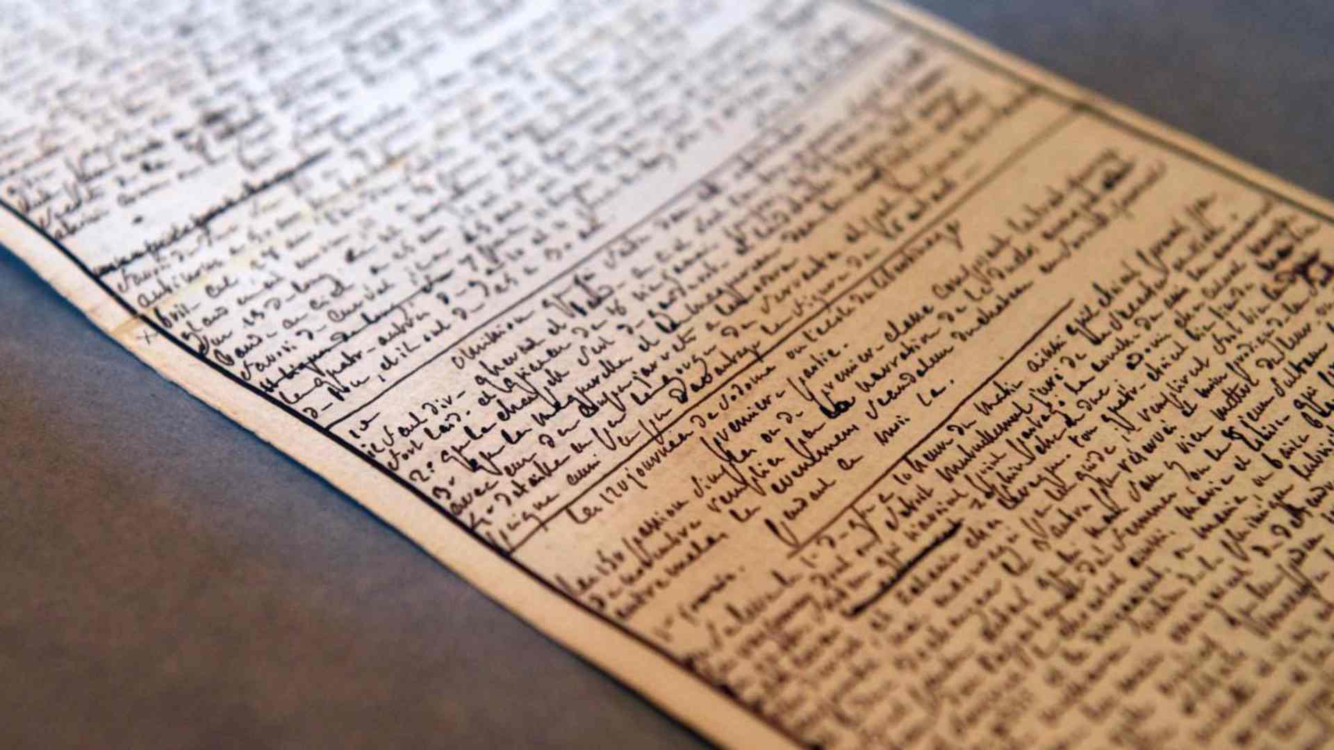 A photo taken on April 2, 2014 at the Institut des Lettres et des Manuscrits de Paris shows the manuscript of "The 120 Days of Sodom" written by the Marquis de Sade while he was imprisoned at the Bastille in 1785. Sade wrote the manuscript in tiny script on both sides of a sheaf of narrow paper, whose sheets he attached into a single 39-foot-long roll. Fearing that his work would be confiscated, he hid the roll in a crevice in a stone wall of his cell. AFP PHOTO / MARTIN BUREAU (Photo credit should read MARTIN BUREAU/AFP via Getty Images)