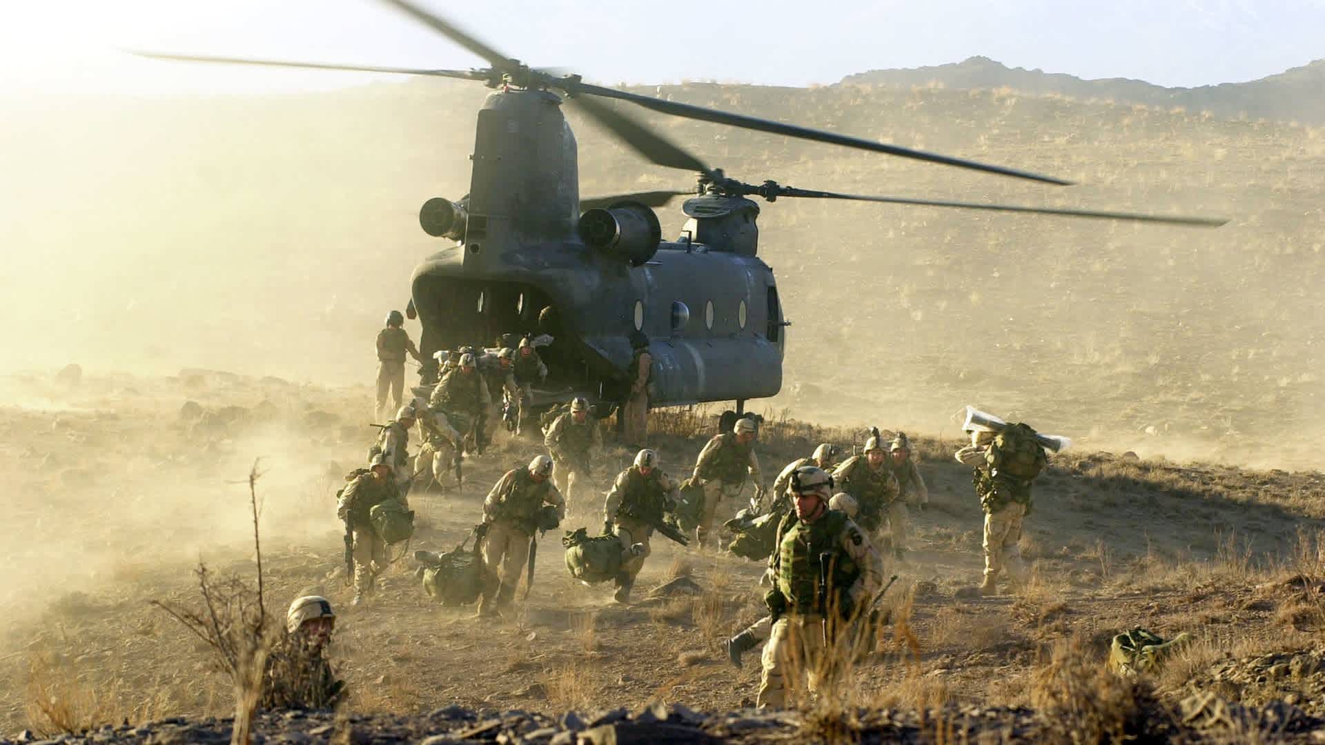 U.S. Army soldiers from the 101st Airborne division off load during a combat mission from a Chinook 47 helicopter March 5, 2002 in Eastern Afghanistan. The soldiers were participating in the largest American offensive since the beginning of the war in Afghanistan.