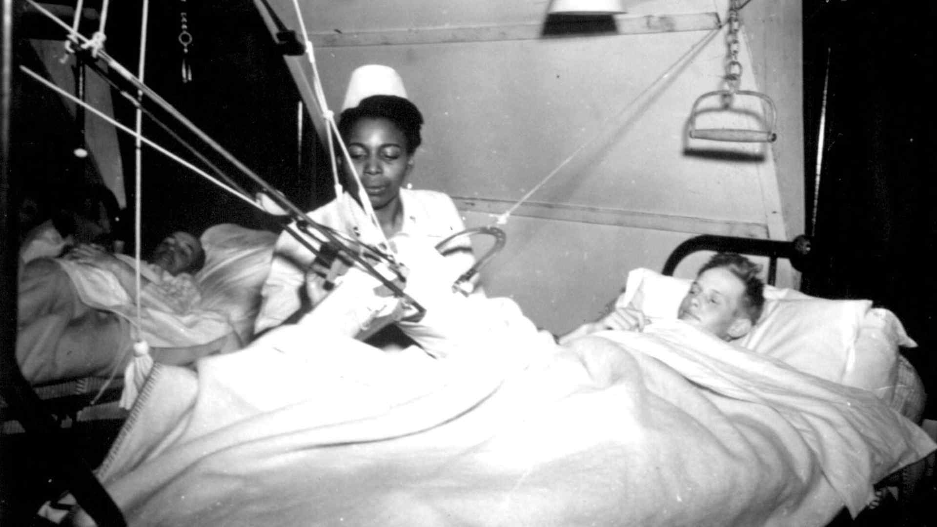 Lt. Florie E. Grant tending to a patient at a prisoner of war hospital, 1944