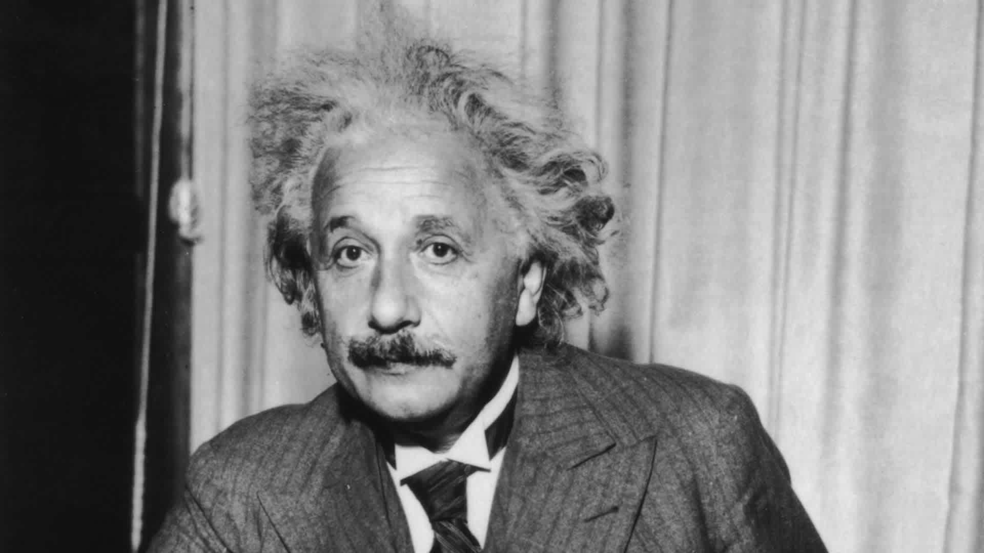 Albert EinsteinPortrait of physicist Albert Einstein, sitting at a table holding a pipe, circa 1933. (Photo by Lambert/Keystone/Getty Images)