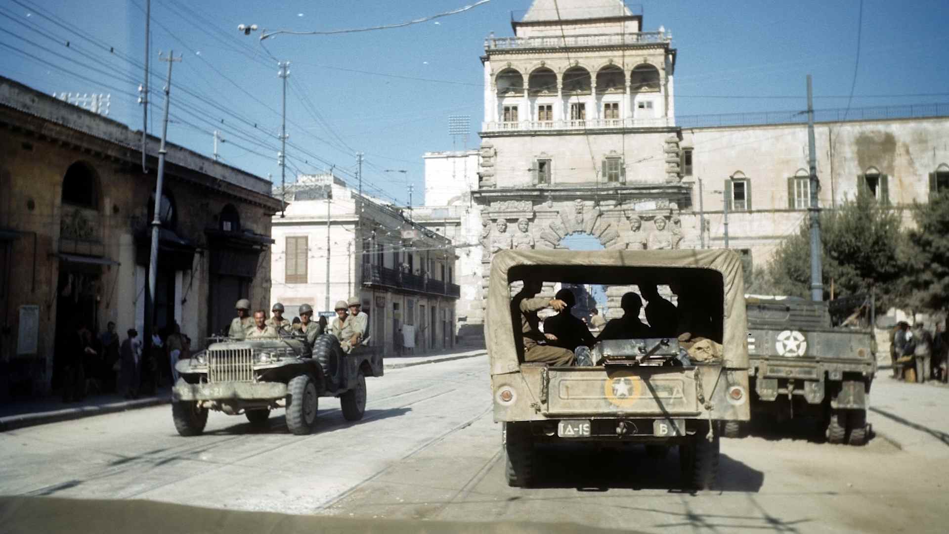 PALERMO, SICILY - AUGUST 22, 1943: A view as Allied forces drive through town after the invasion of Sicily, 5 days after winning the campaign called Operation Husky, during the World War II in Palermo, Sicily, Italy. (Photo by Ivan Dmitri/Michael Ochs Archives/Getty Images)