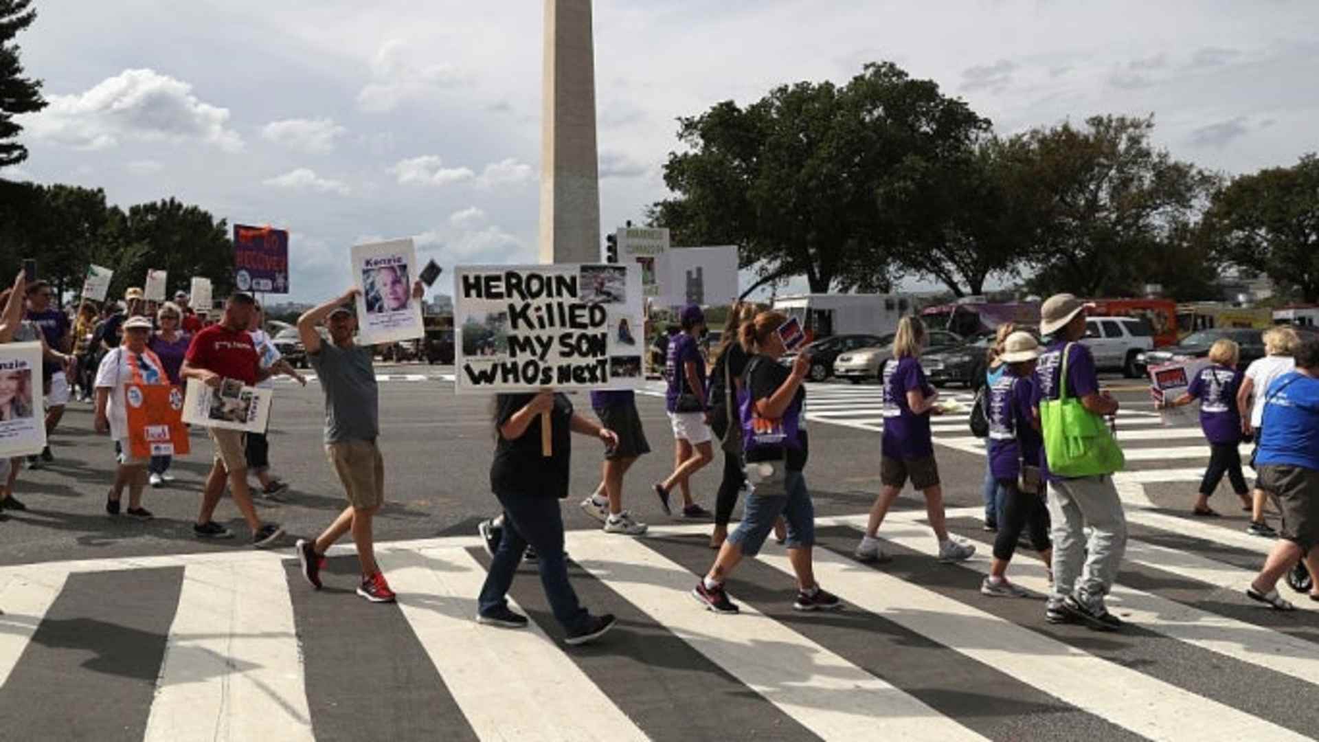 Activists and family members of loved ones who died in the opioid/heroin epidemic march in a "Fed Up!" rally on the National Mall on September 18, 2016.