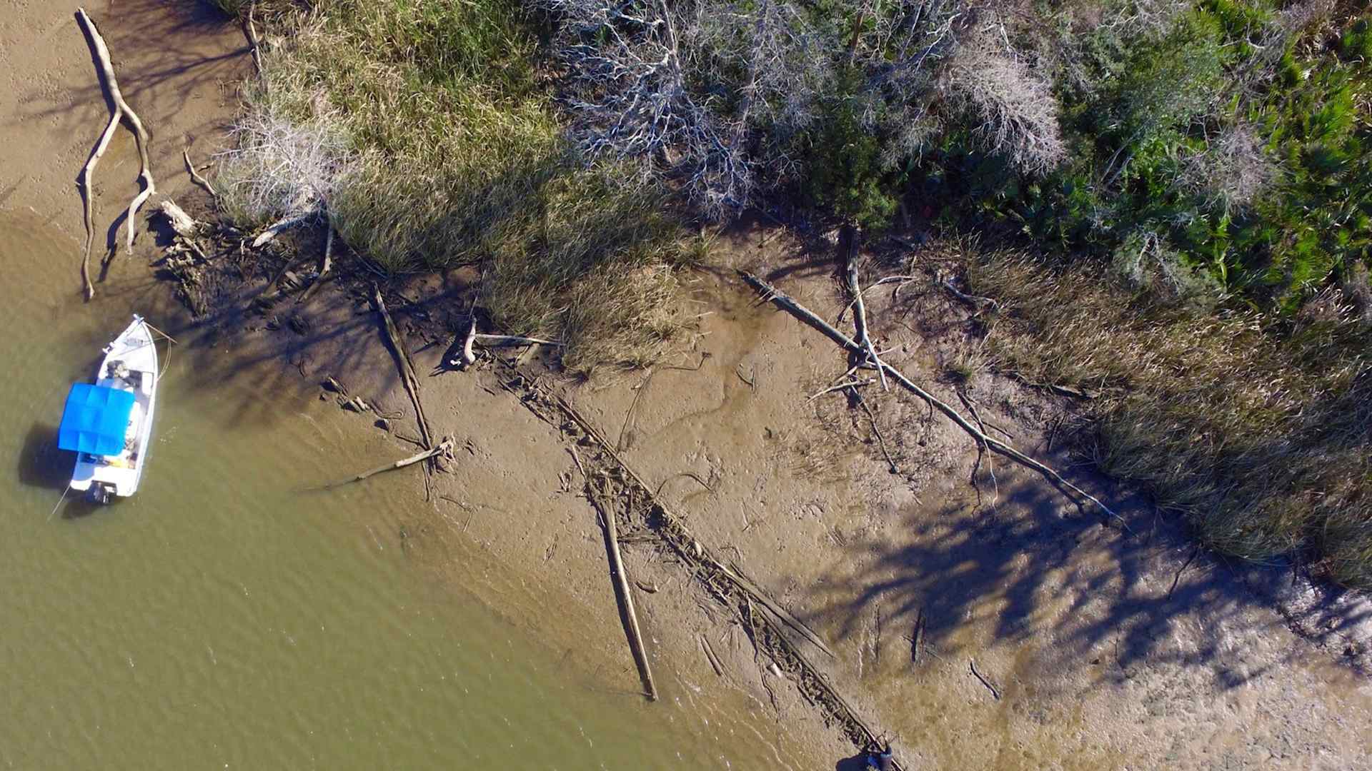 This aerial photo taken Tuesday, Jan. 2, 2018, in Mobile County, Ala., shows the remains of a ship that could be the Clotilda, the last slave ship documented to have delivered captive Africans to the United States. The Clotilda was burned after docking in Mobile, Ala., in 1860, long after the importation of humans was banned, and experts say the remains found by a reporter from Al.com could be what is left of the long-lost wreck. (AP Photo/Ben Raines, Al.com)