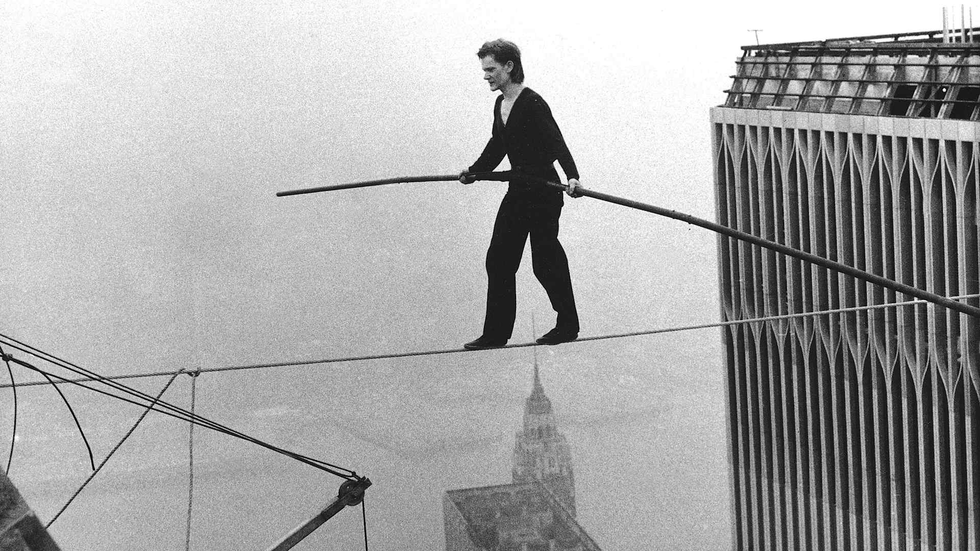 Philippe Petit crossing the Twin Towers on a tightrope.