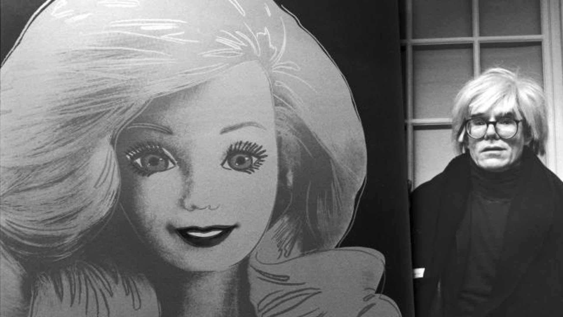 Artist Andy Warhol displaying his portrait of a Barbie doll.  (Credit: DMI/The LIFE Picture Collection/Getty Images)