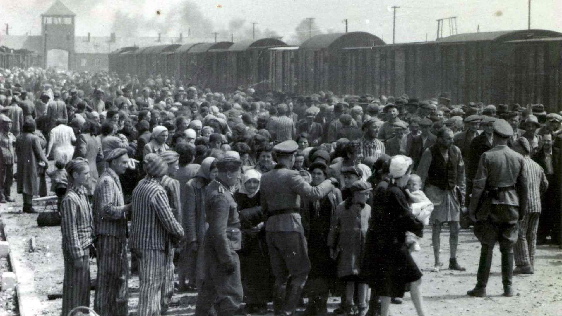TOPSHOT-WWII-CONCENTRATION CAMP-AUSCHWITZTOPSHOT - A photo taken 27 May 1944 in Oswiecim, showing Nazis selecting prisoners on the platform at the entrance of the Auschwitz-Birkenau extermination camp. The Auschwitz camp was established by the Nazis in 1940, in the suburbs of the city of Oswiecim which, like other parts of Poland, was occupied by the Germans during the Second World War. The name of the city of Oswiecim was changed to Auschwitz, which became the name of the camp as well. Over the following years, the camp was expanded and consisted of three main parts: Auschwitz I, Auschwitz II-Birkenau, and Auschwitz III-Monowitz. Red Army soldiers liberated the few thousand prisoners whom the Germans had left behind in the camp, 27 January 1945. AFP PHOTO/ YAD VASHEM ARCHIVES (Photo by Yad Vashem Archives / AFP) (Photo by -/Yad Vashem Archives/AFP via Getty Images)