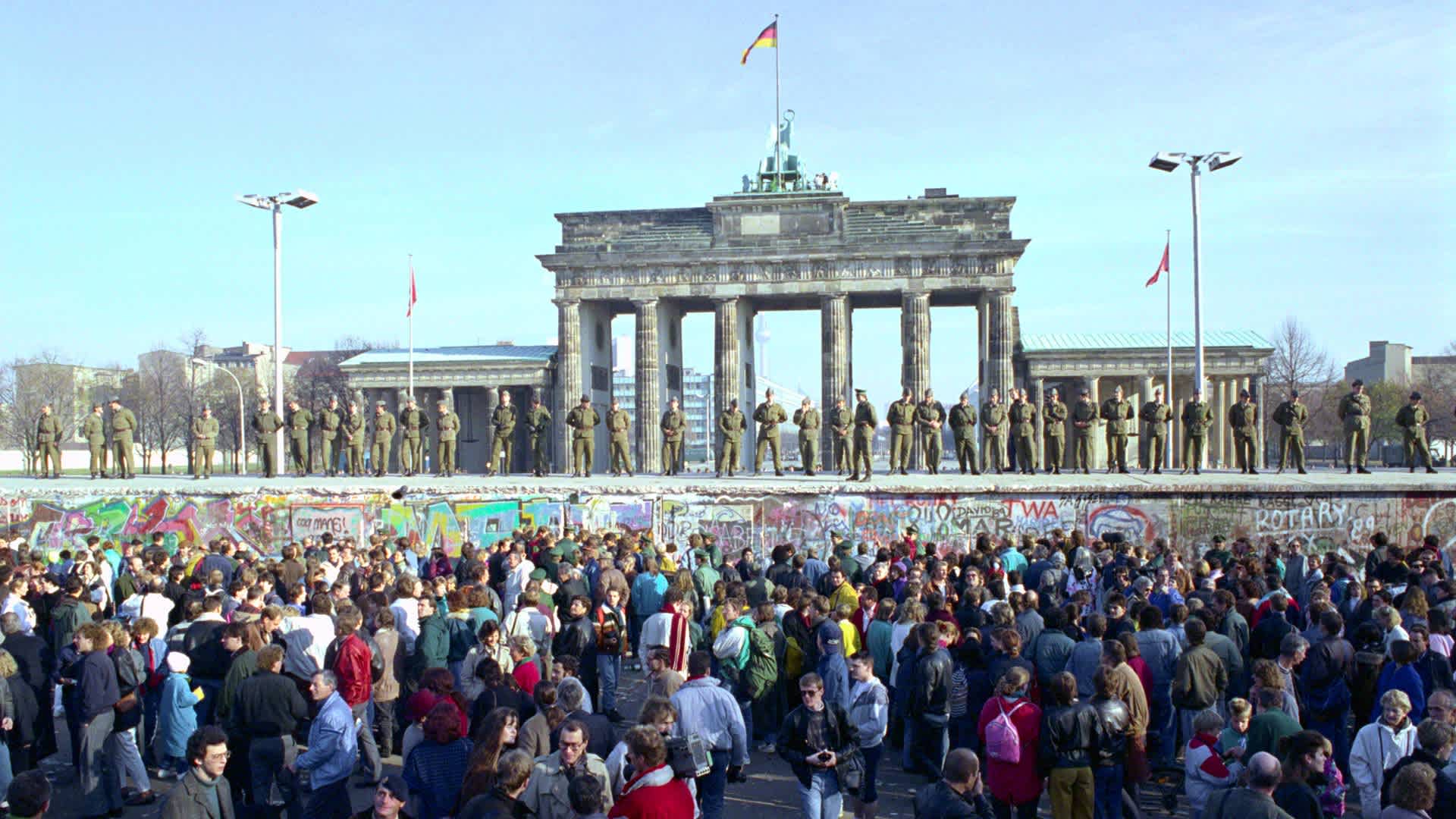 East Germans at Brandenburg GateEast Germans wait for money being given to them by banks in West Berlin. (Photo by David Turnley/Corbis/VCG via Getty Images)