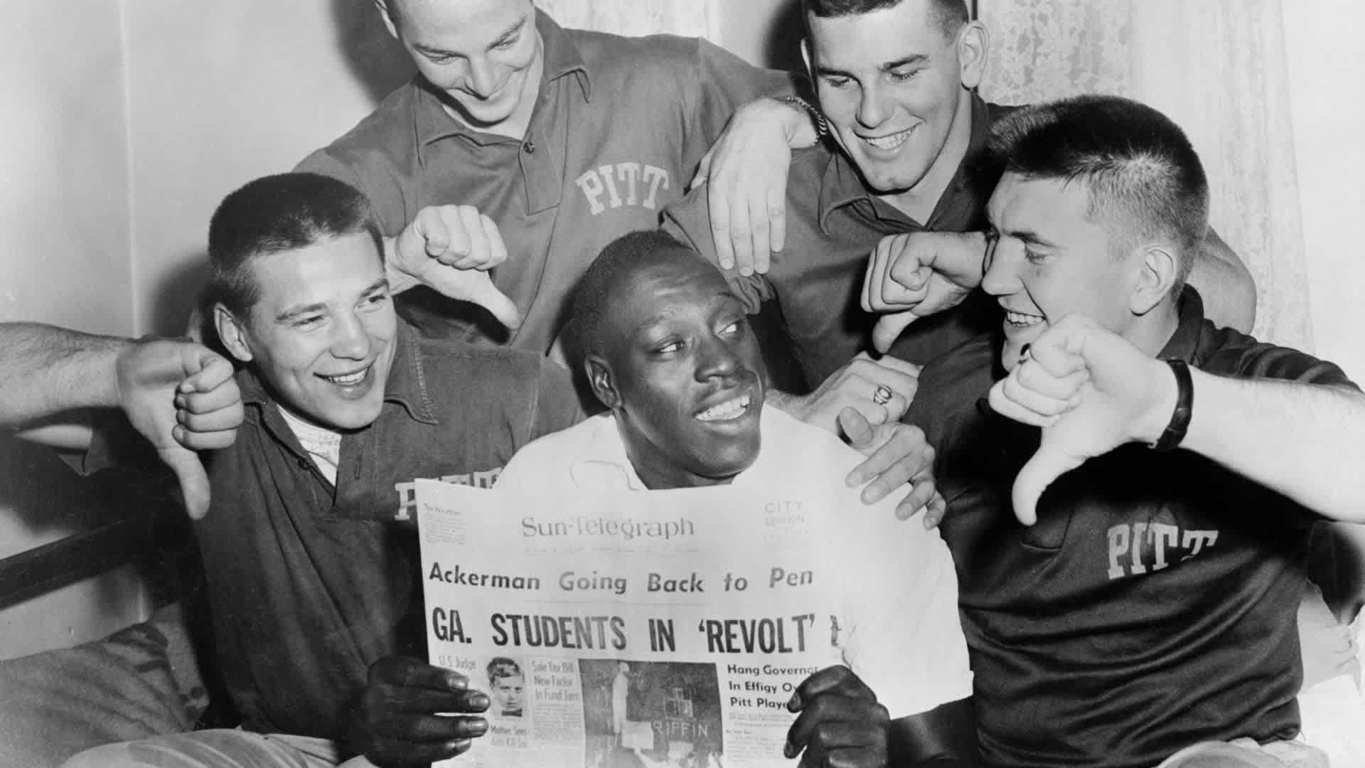 Teammates show Bobby Grier, (C), what they think of Georgia Governor Marvin Griffin's threat to block Georgia Tech from playing in the Sugar Bowl on January 2nd, if the University of Pittsburgh's Negro player is part of the Panther team. Gathered around Grier from the left are: Bob Kiesel, end; Nick Carr, Guard; Jim McCuskar, tackle and Don Agafon, tackle. Two thousand Georgia Tech students staged a protest demonstration in which they twice burned the Governor in effigy. The case was scheduled to go before the Georgia State Board of Regents.