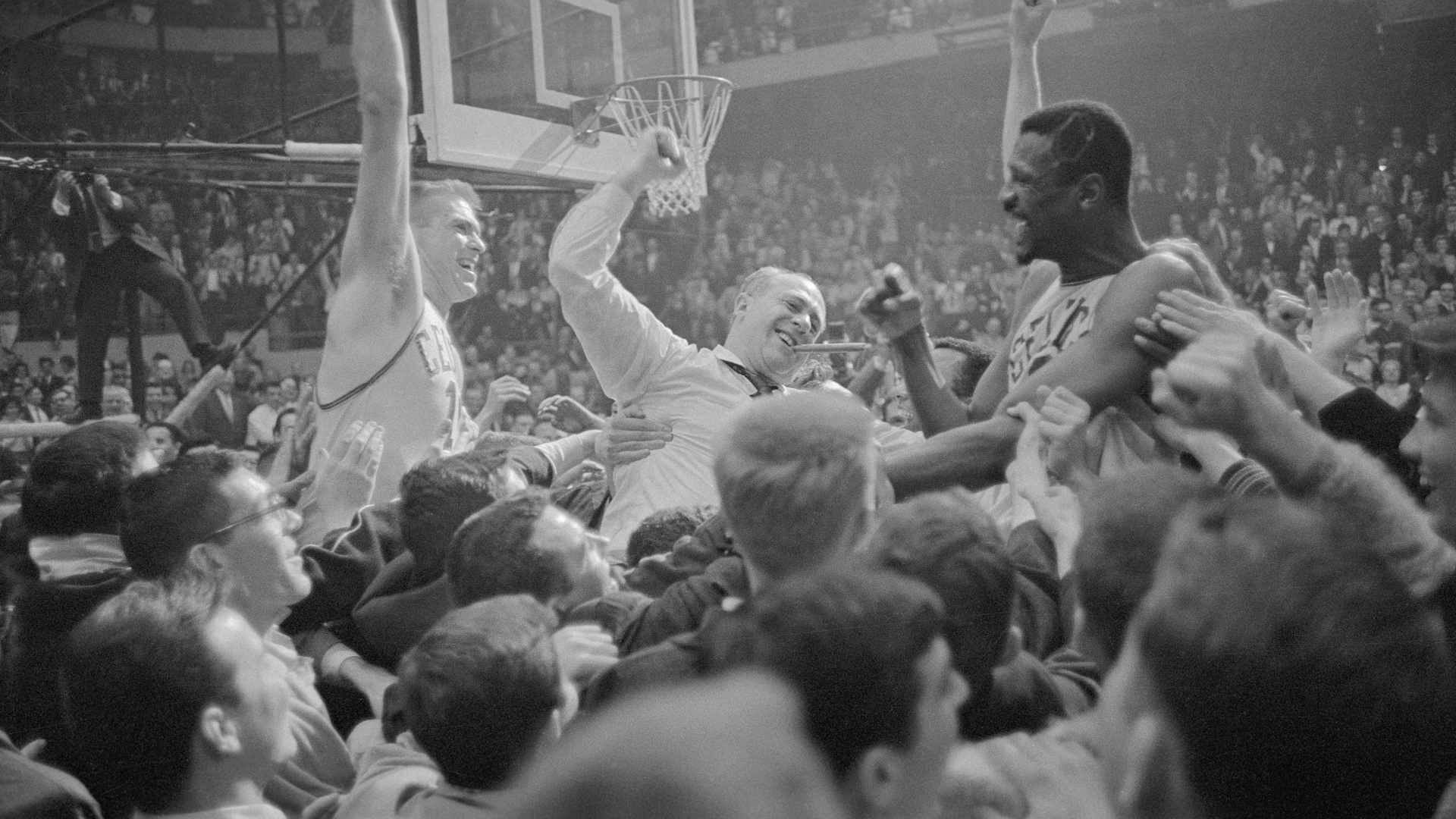 It's a jubilant mob scene as happy fans carry Celtics' Tommy Heinsohn, coach Red Auerbach (center) Bill Russell celebrate an NBA title in 1965.