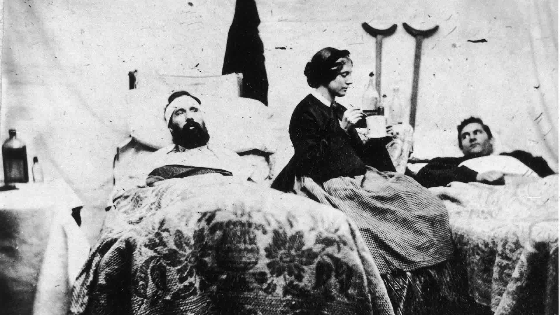 A nurse prepares to spoon-feed soldiers in this photograph taken by Jim Enos inside the Union hospital at Carlisle Barracks, Pennsylvania, circa 1861.