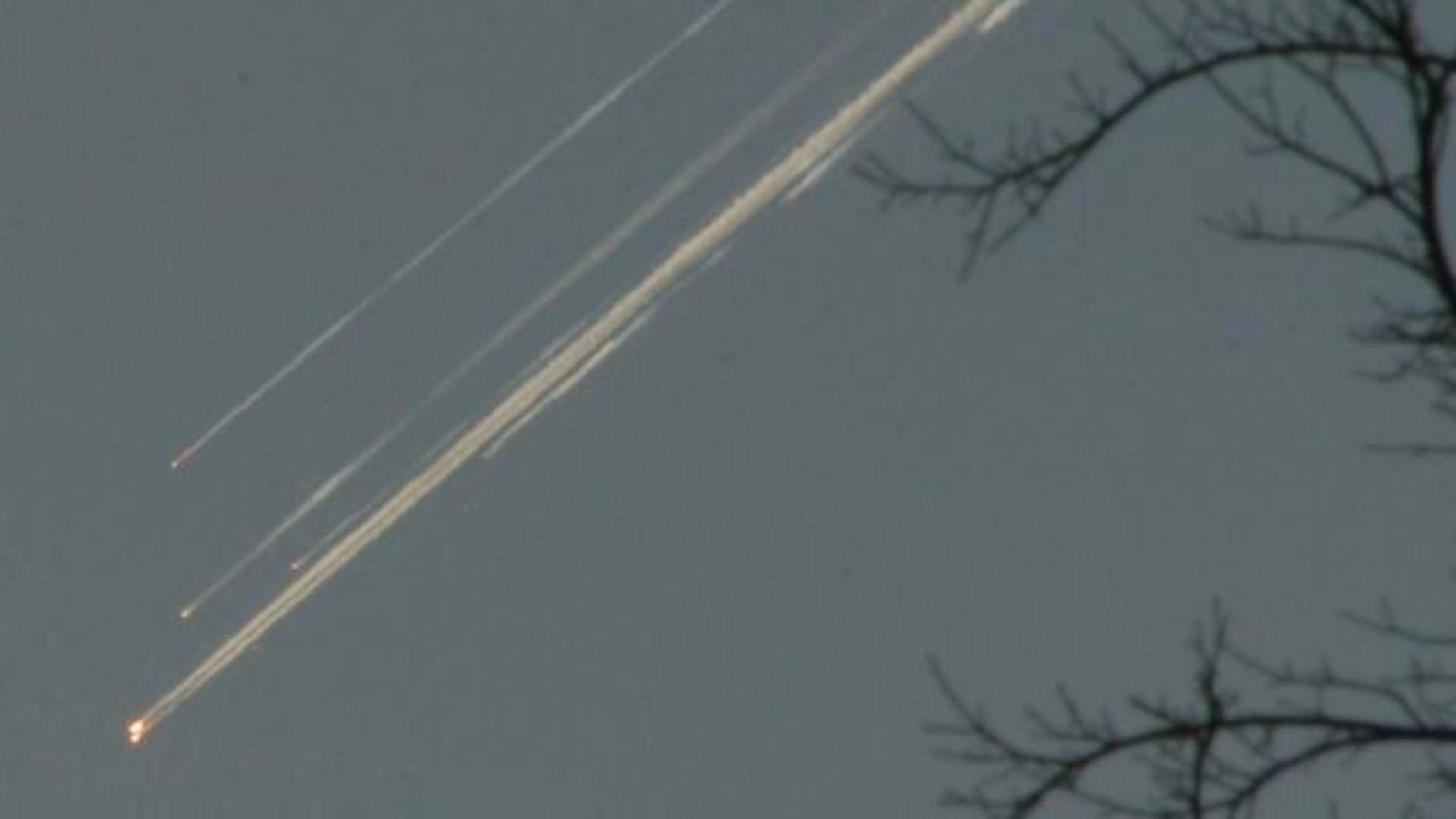 Debris from the space shuttle Columbia streaks across the Texas sky as seen from Dallas. (Credit: Jason Hutchinson/AP/REX/Shutterstock)