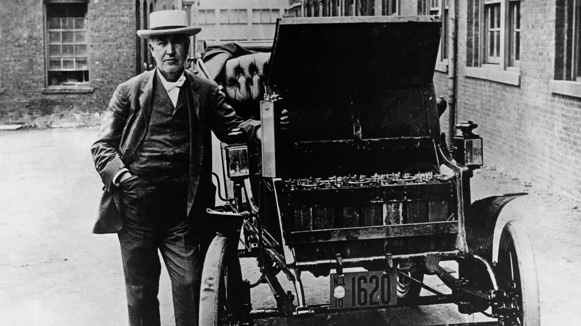 Thomas A. Edison stands next to his American Barker electric car, circa 1895.