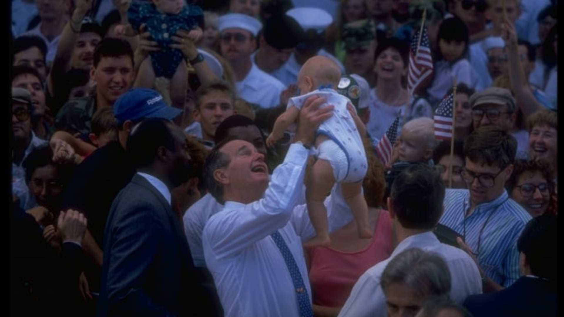 President Bush holding baby.