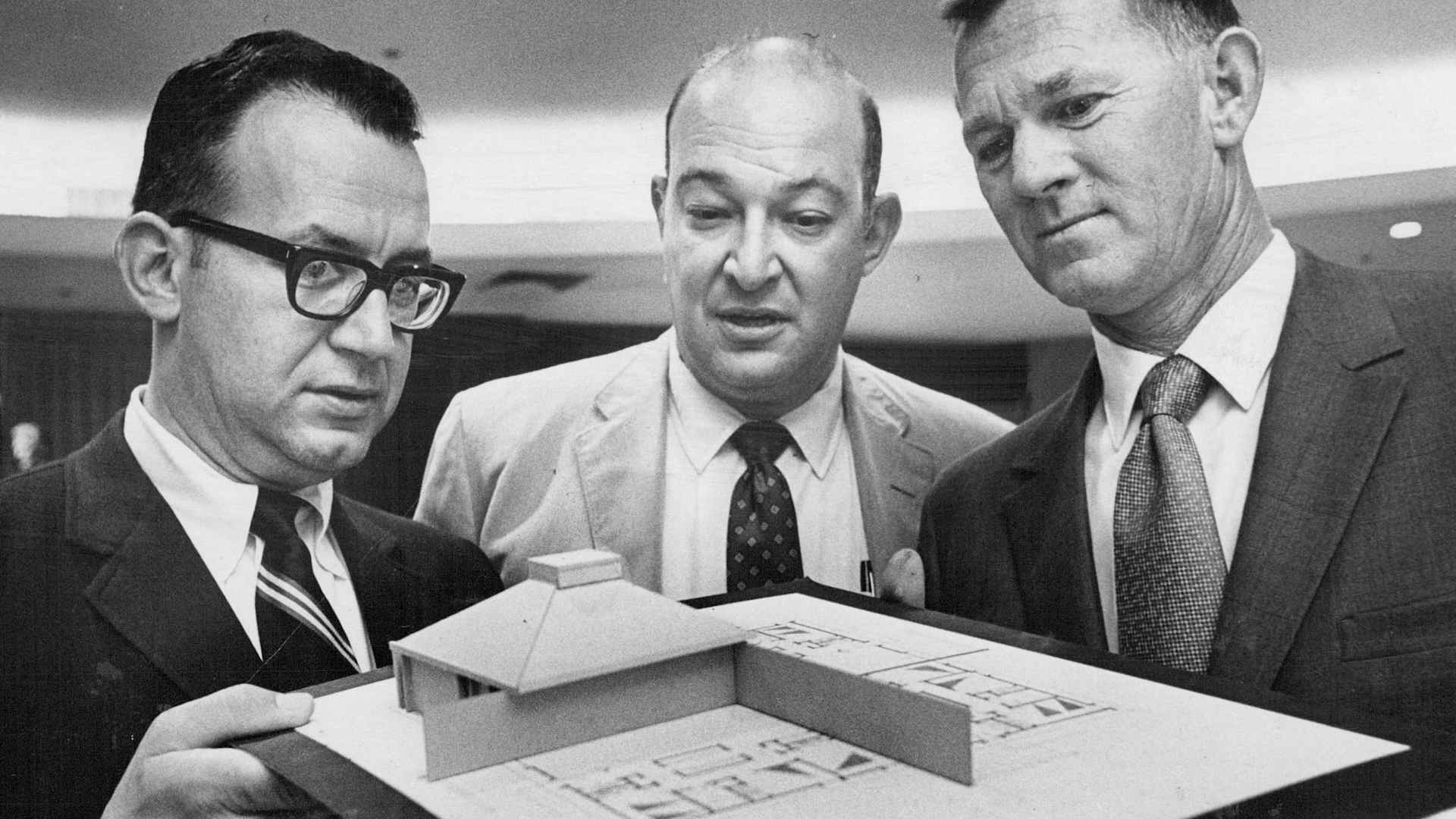 AUG 28 1969 Model Of the Four- Unit Housing Complex is on Display At Coalition Meet Around it are, from left, Charles Henning, Ed Lashman and Warren Shannon.