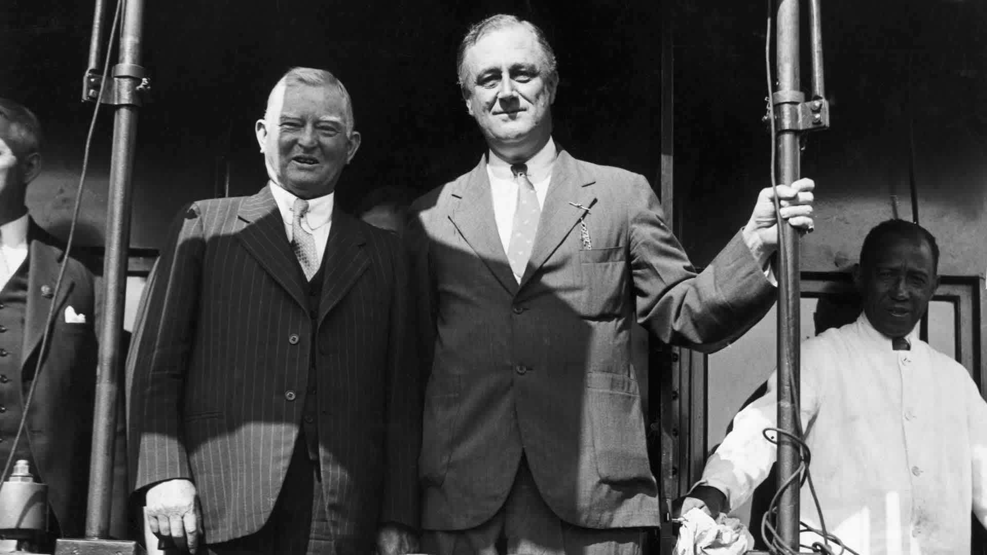 Vice presidential candidate John Nance Garner stands at the back of a special campaign train with presidential candidate Franklin Delano Roosevelt during a stop in Topeka, Kansas.