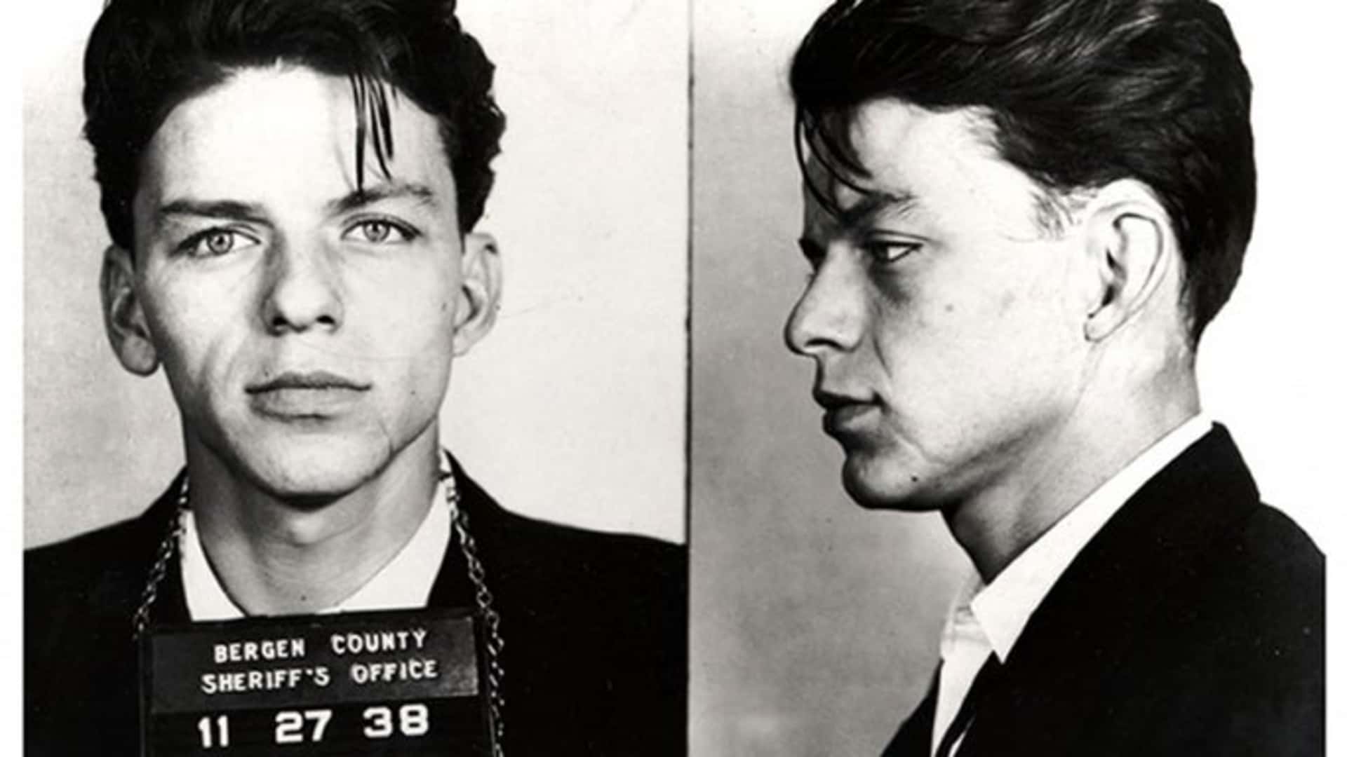Singer Frank Sinatra posing for a mug shot after being arrested and charged with "carrying on with a married woman" in 1938 in Bergen County, New Jersey. A scan of this mugshot was included in Sinatra's FBI file.