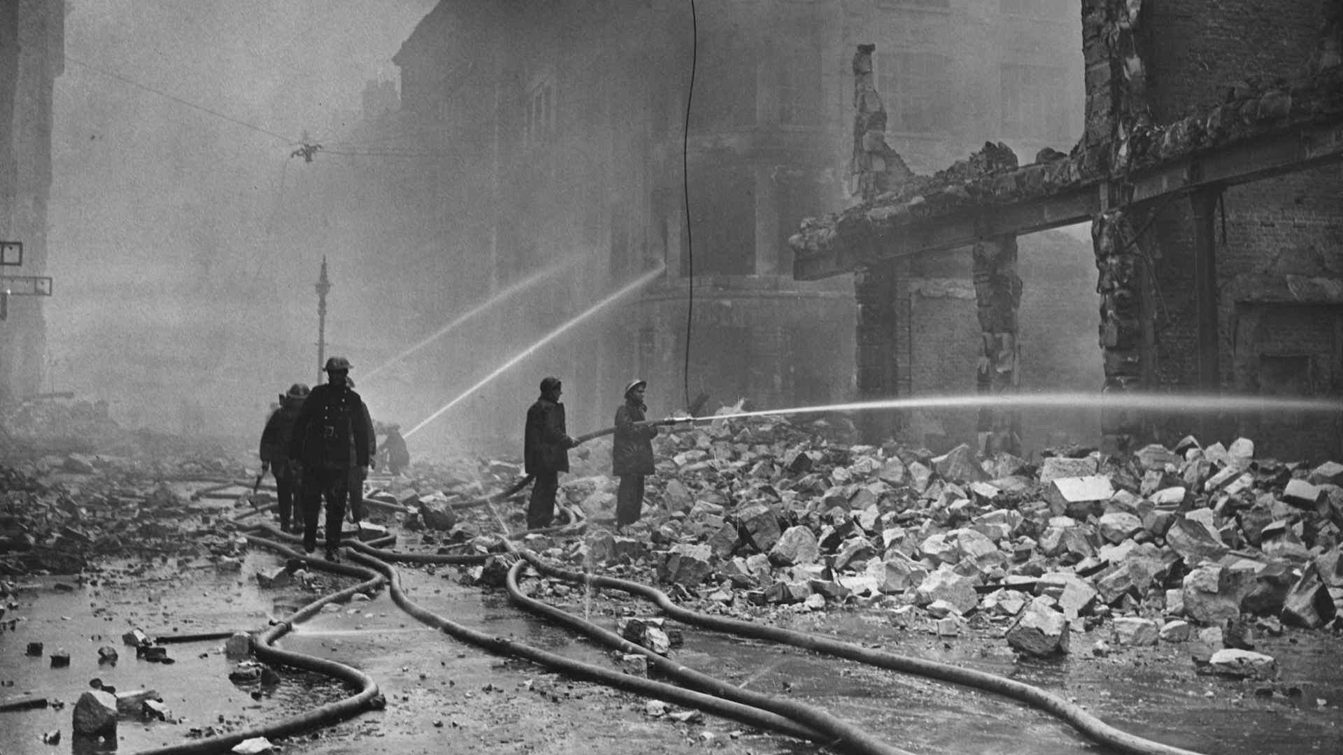 Firefighters combat a blaze in the City of London after a German Luftwaffe World War II bombing raid during The Blitz and Battle of Britain in 1940.