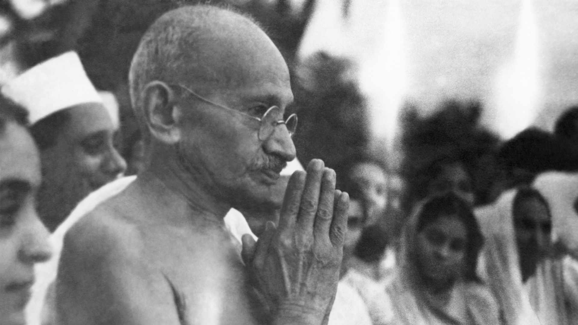 Indian statesman and activist Mohandas Karamchand Gandhi (1869 - 1948) greeting people at Juhu Beach, Mumbai, May 1944.