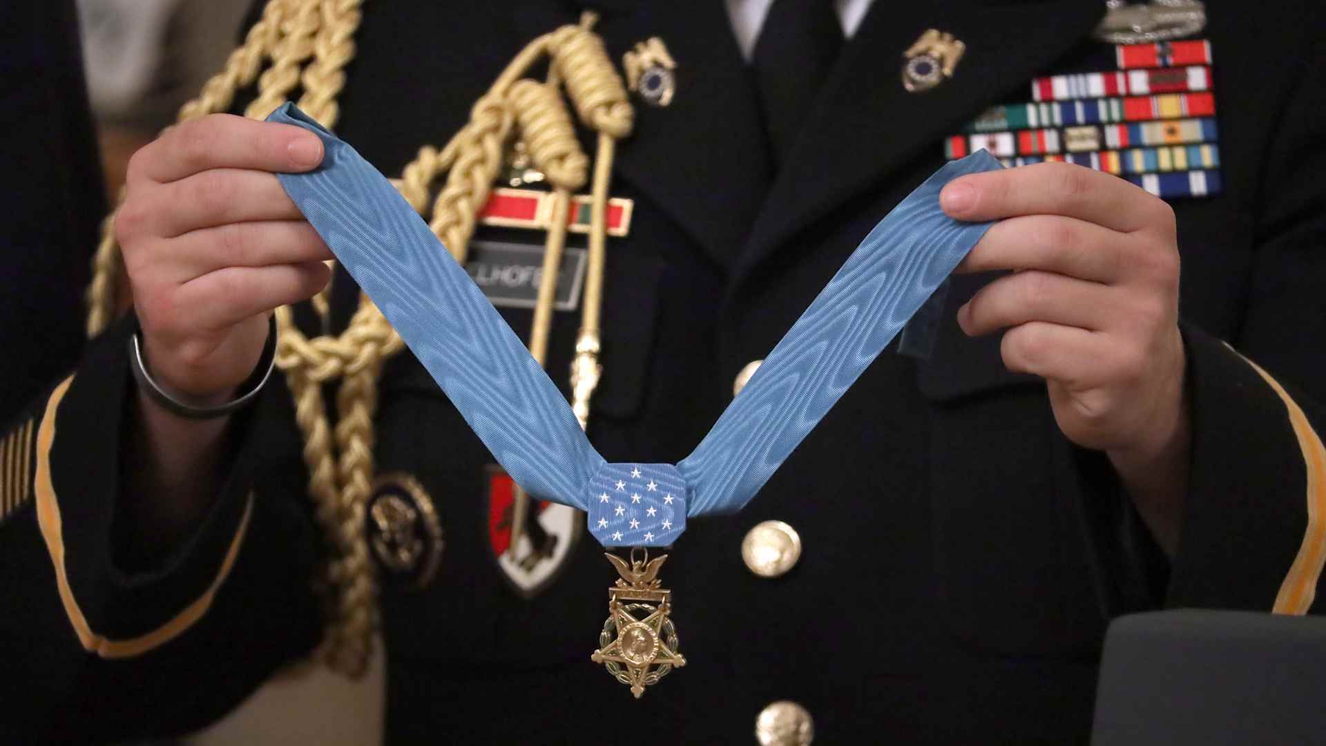 WASHINGTON, DC - OCTOBER 30: A military aide holds U.S. Army Master Sgt. Matthew Williams' Medal of Honor during a ceremony in the East Room of the White House October 30, 2019 in Washington, DC. Serving with Special Forces Operational Detachment Alpha in Afghanistan's Shok Valley in 2008, Williams repeatedly risked his life to evacuate four wounded teammates and lead counterassaults after they were pinned down by enemy fire during a mission to capture or kill high-value targets. (Photo by Chip Somodevilla/Getty Images)