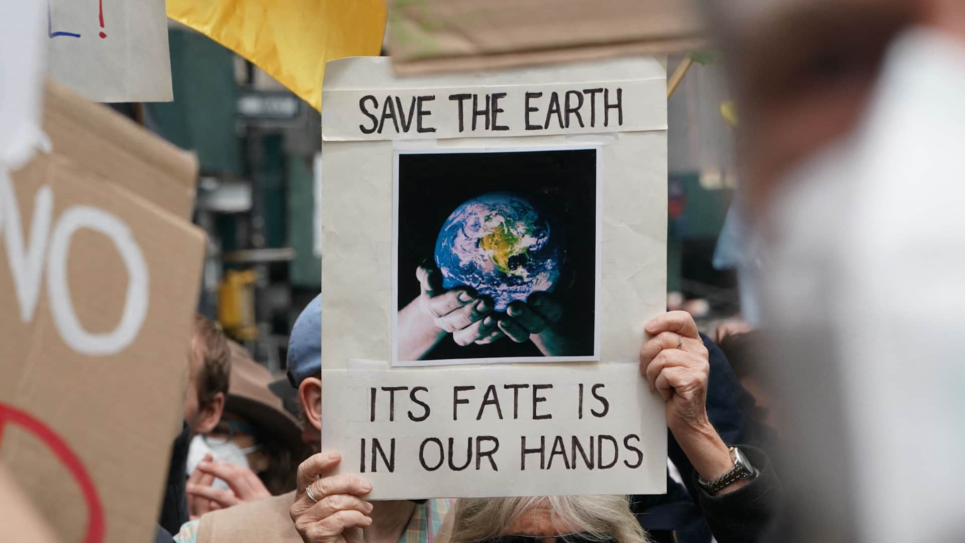 A sign reading "Save the Earth / Its Fate Is In Our Hands" at an Earth Day march in New York City.