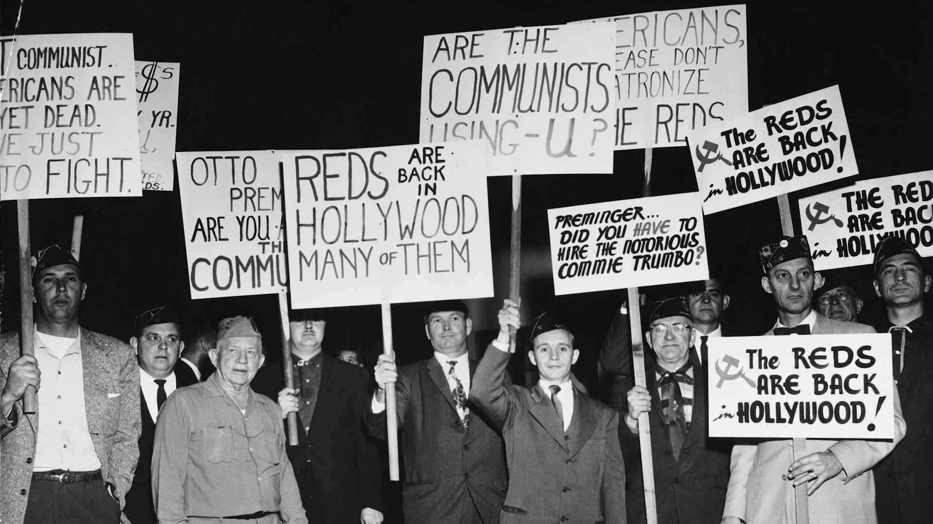 A group of protesters demonstrate holding placards against Communist sympathizers outside the Fox Wilshire Theatre in occasion of the premiere of film 'Exodus', which marked the end of the 'Hollywood Blacklist' when screen player Dalton Trumbo, a Communist Party member from 1943 to 1948 and member of the Hollywood Ten, was credited as the screenwriter of the film, Beverly Hills, Los Angeles, California, US, December 1960. (Photo by American Stock Archive/Archive Photos/Getty Images)