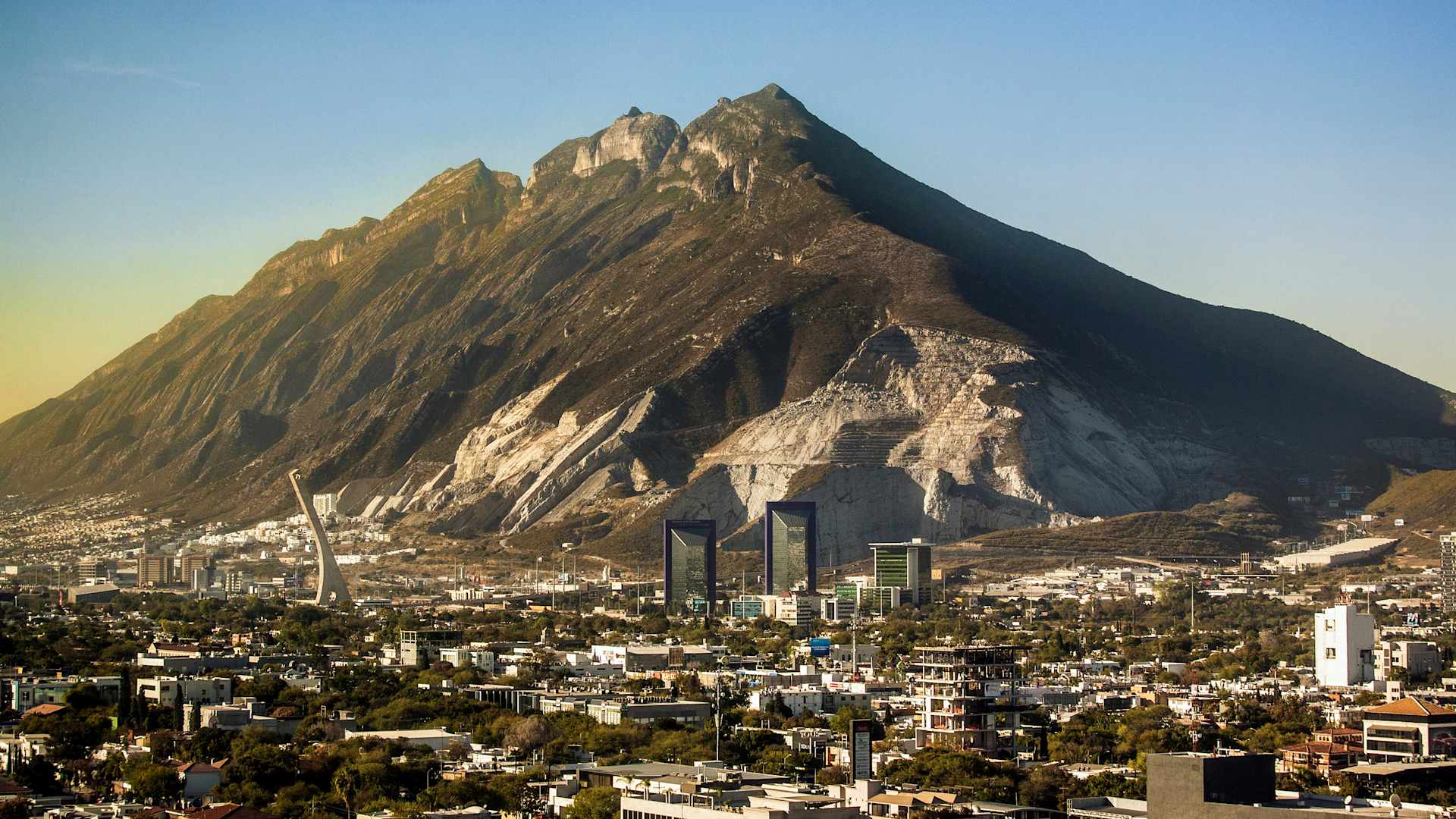 Mountain Cerro del Topo Chico rises over northeastern metropolitan and business area of city of Monterrey in state of Nuevo León Mexico.
