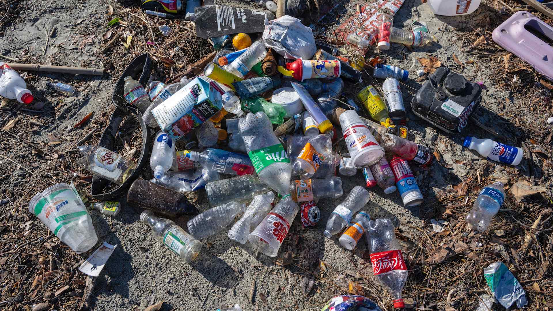 Plastic bottles and other trash piled up along the bank of the San Gabriel River just a few hundred yards from the Pacific Ocean in Seal Beach, California.