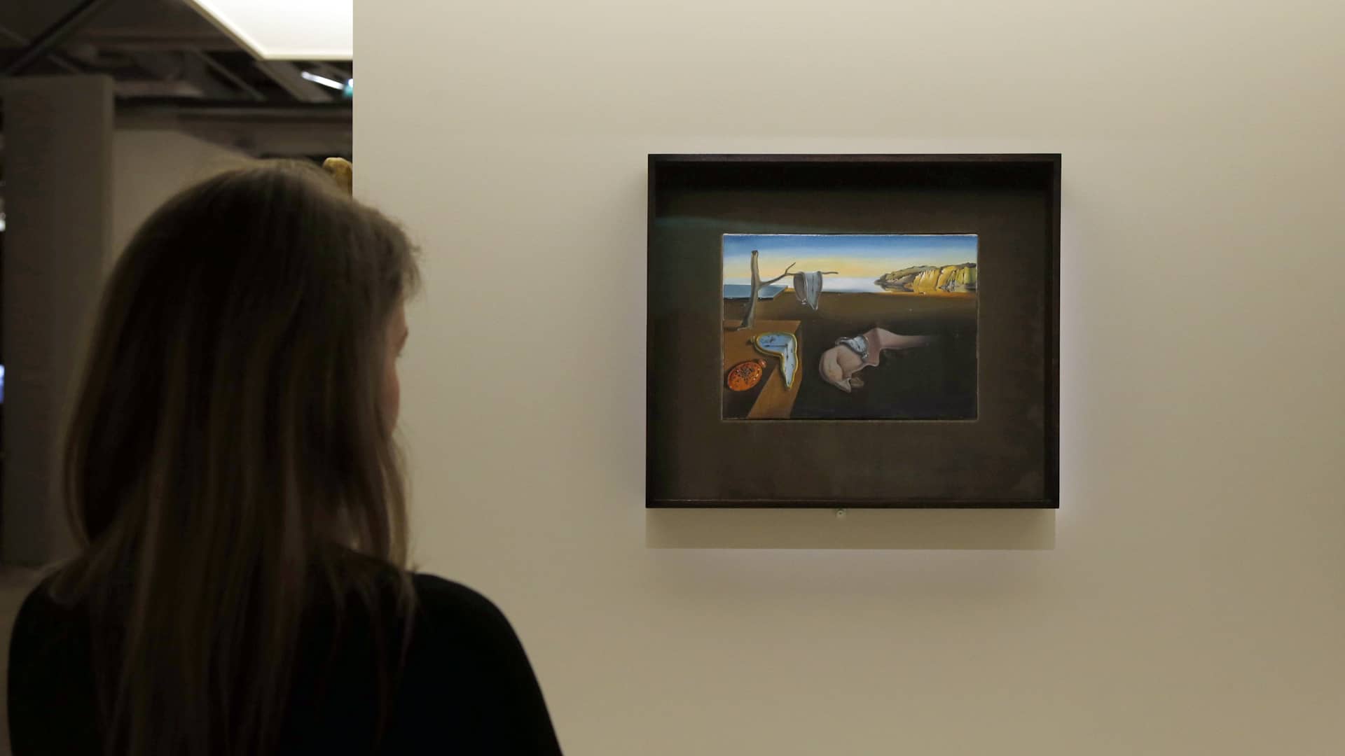 A visitor looks at a painting entitled "La persistance de la mémoire" (Persistence of Memory) by Spanish surrealist artist Salvador Dali's during an exhibition devoted to his work at the Centre Pompidou contopary art center (aka Beaubourg) on November 19, 2012 in Paris. More than 30 years after the first retrospective in 1979, the event gathers more than 200 art pieces and runs until March 13, 2013. AFP PHOTO FRANCOIS GUILLOT (Photo credit should read FRANCOIS GUILLOT/AFP via Getty Images)