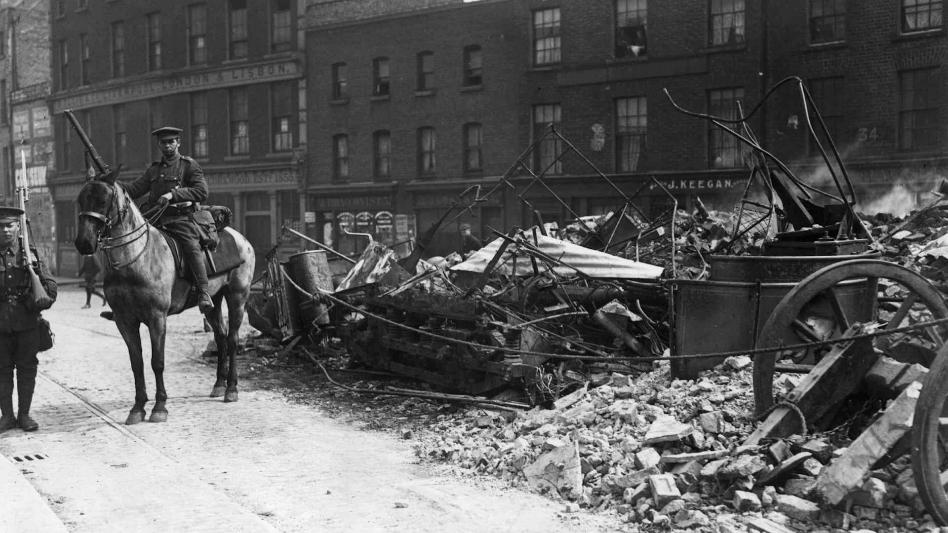A Lancer on guard in Dublin beside a tramcar used as a barricade during the Easter Rising. Fighting occurred after members of the Irish Citizen Army and the Irish Volunteers took control of the General Post Office under the leadership of Patrick Pearce and James Connolly.