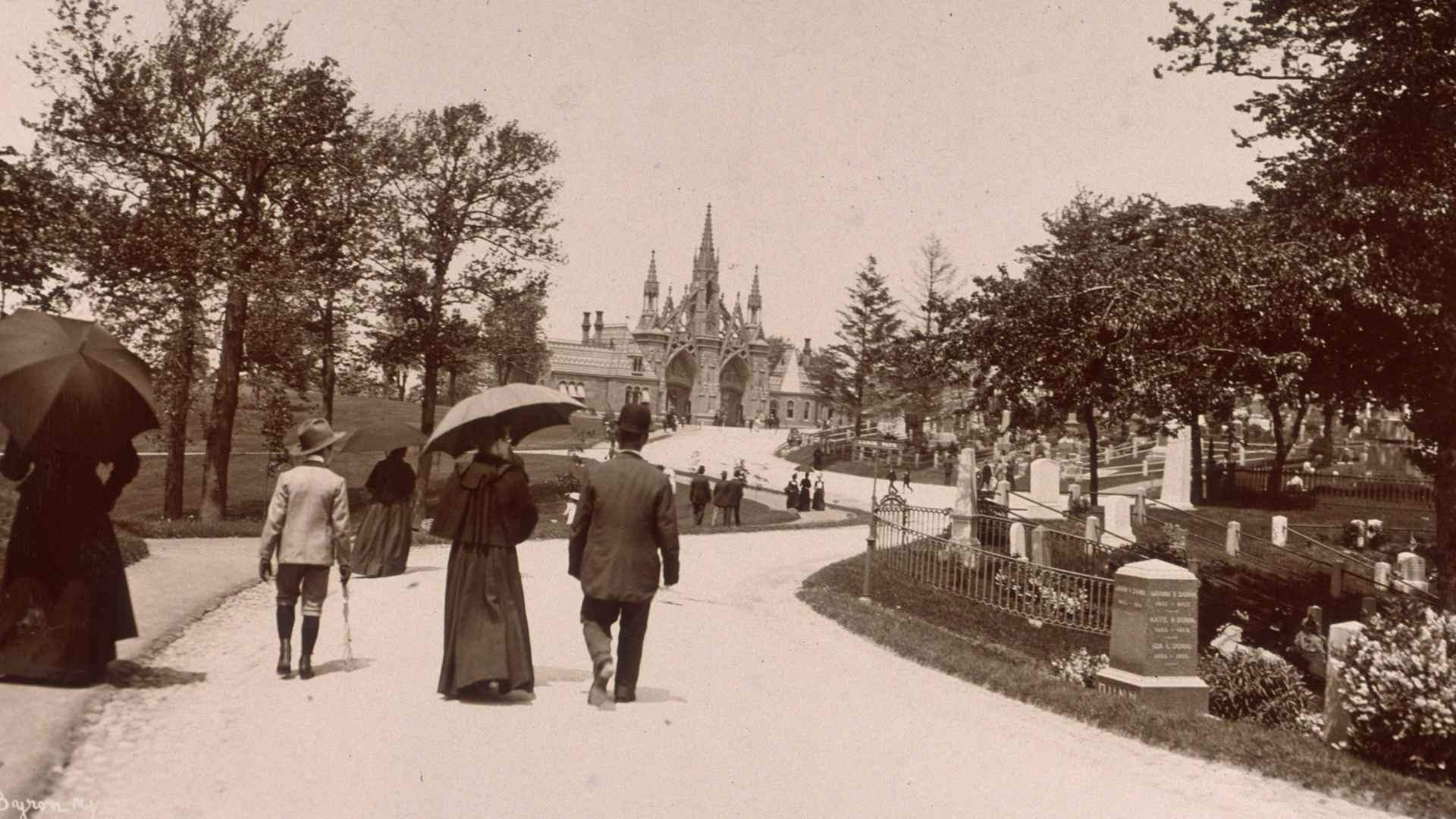 30th May 1899: Several people stroll up a path at the Green-Wood Cemetery, located at Fifth Avenue and Twenty-Fifth Street in Brooklyn, New York.