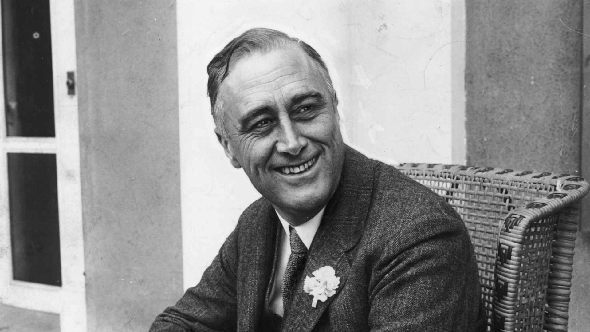 American statesman Franklin Delano Roosevelt (1882 - 1945) smiling when he heard that he was leading the contest for Governor of New York State. He later became the 32nd President of the USA.