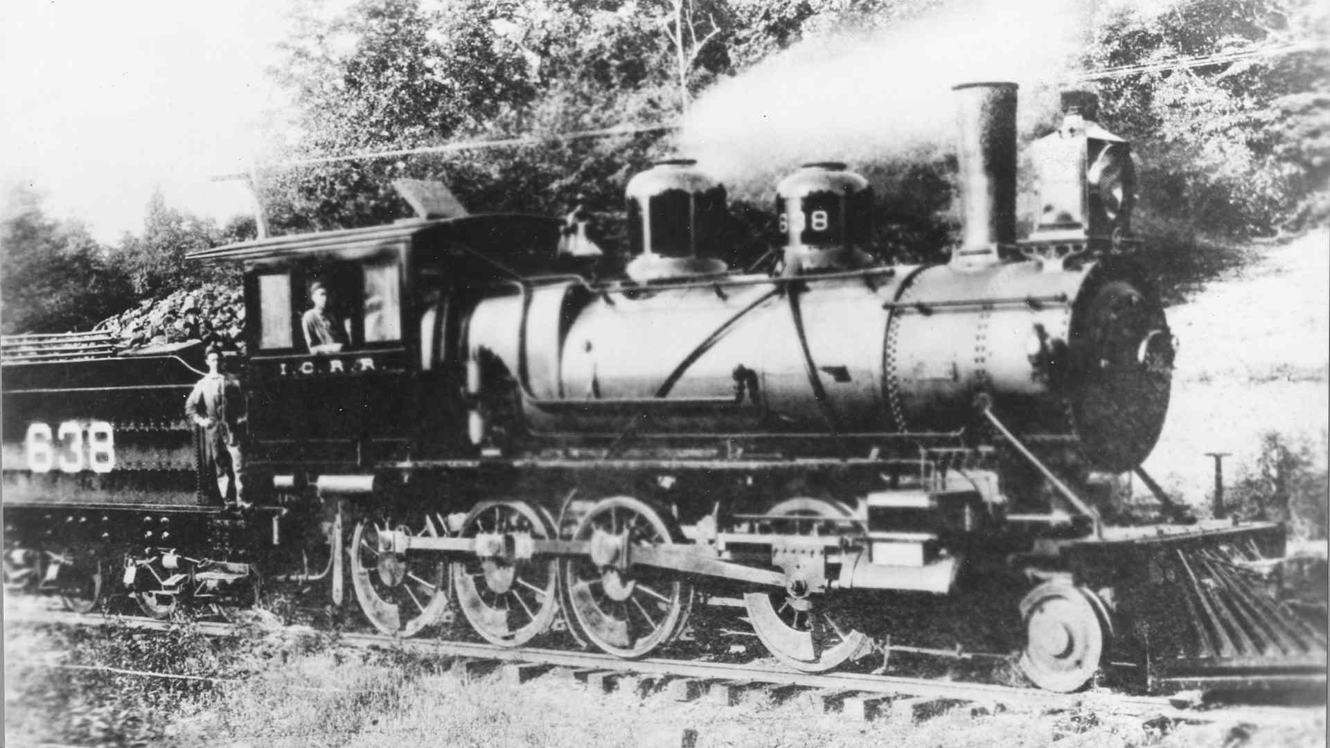 Famed train engineer Casey Jones, sitting in the cab of engine No 638, 1900. This photo was taken shortly after Jones was assigned to the engine. JW McKinnie, standing in the gangway is the man who fired for Casey for two years. This famous locomotive was known for its highly polished six-chime bell. (Photo by PhotoQuest/Getty Images)