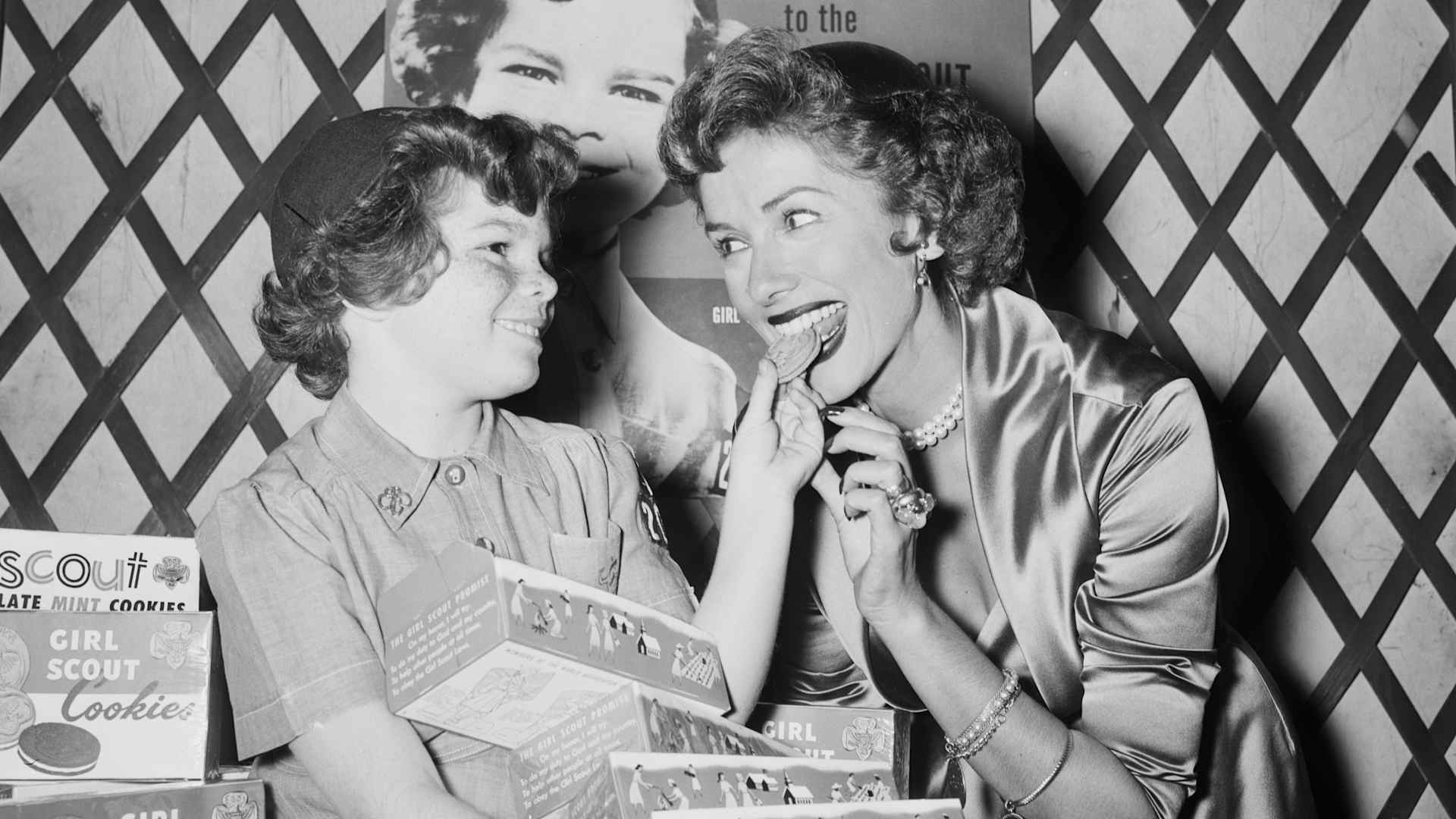 Girl Scout offers cookie to TV's Jinx Falkenburg McCrary, marking opening of $650,000 fund drive by the Girl Scout Council of Greater New York. BPA2# 1264