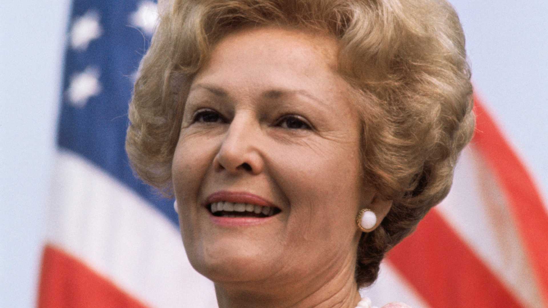 (Original Caption) McLean, Virginia: Mrs. Richard Nixon is pictured with the American flag during ceremonies at McLean, Virginia, where she started a five state visit to see the tangible results of the president's "Legacy of Parks" program.