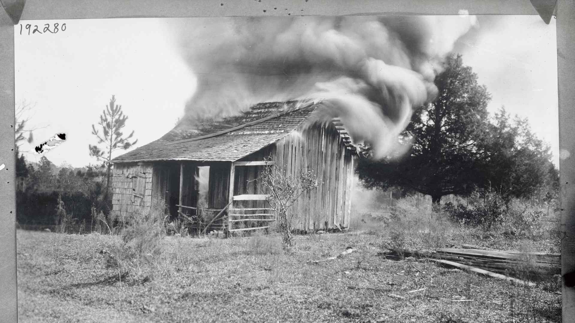 A burning home during the Rosewood Massacre in Florida, 1923.