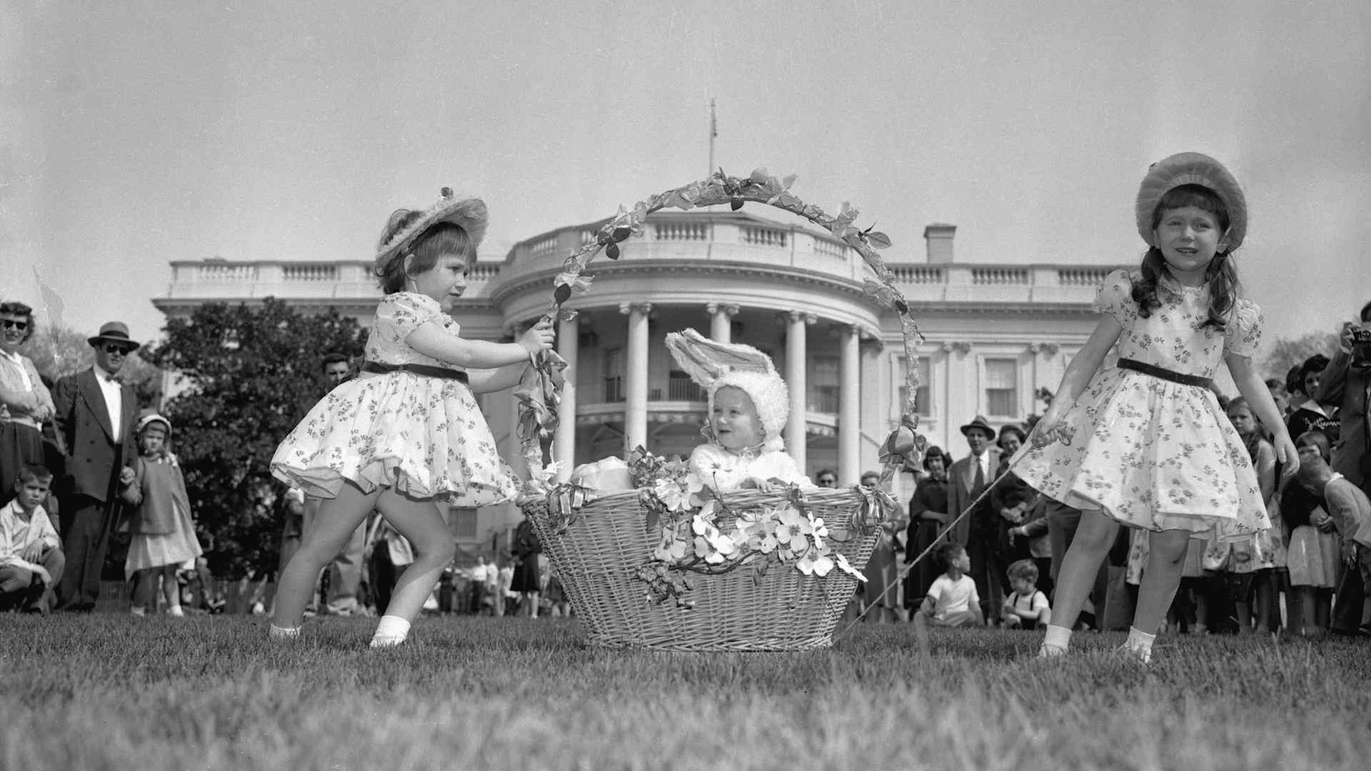 Three sisters at the Traditional Easter Egg Roll on the White House lawn. President Eisenhower hosted the event, which first started in 1878.