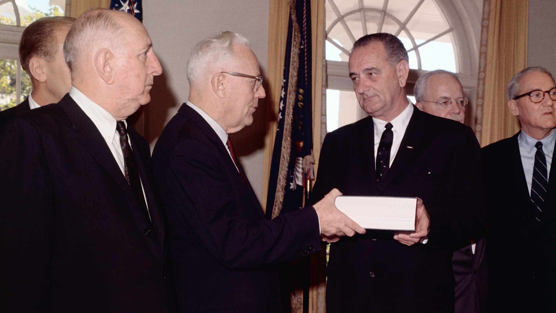 President LBJ receiving the Warren Commission report on the Kennedy assassination.
