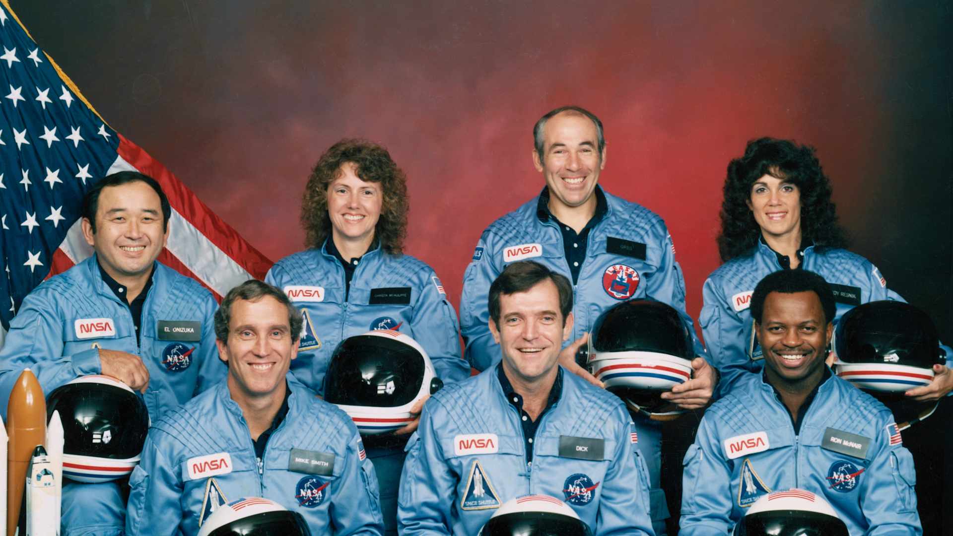 Five astronauts and two payload specialists make up the STS 51-L crew, scheduled to fly aboard the Space Shuttle Challenger in January of 1986. Crewmembers are (left to right, front row) astronauts Michael J. Smith, Francis R. (Dick) Scobee and Ronald E. McNair; and Ellison S. Onizuka, Sharon Christa McAuliffe, Gregory Jarvis and Judith A. Resnik. McAuliffe and Jarvis are payload specialists, representing the Teacher in Space Project and Hughes Co., respectively.