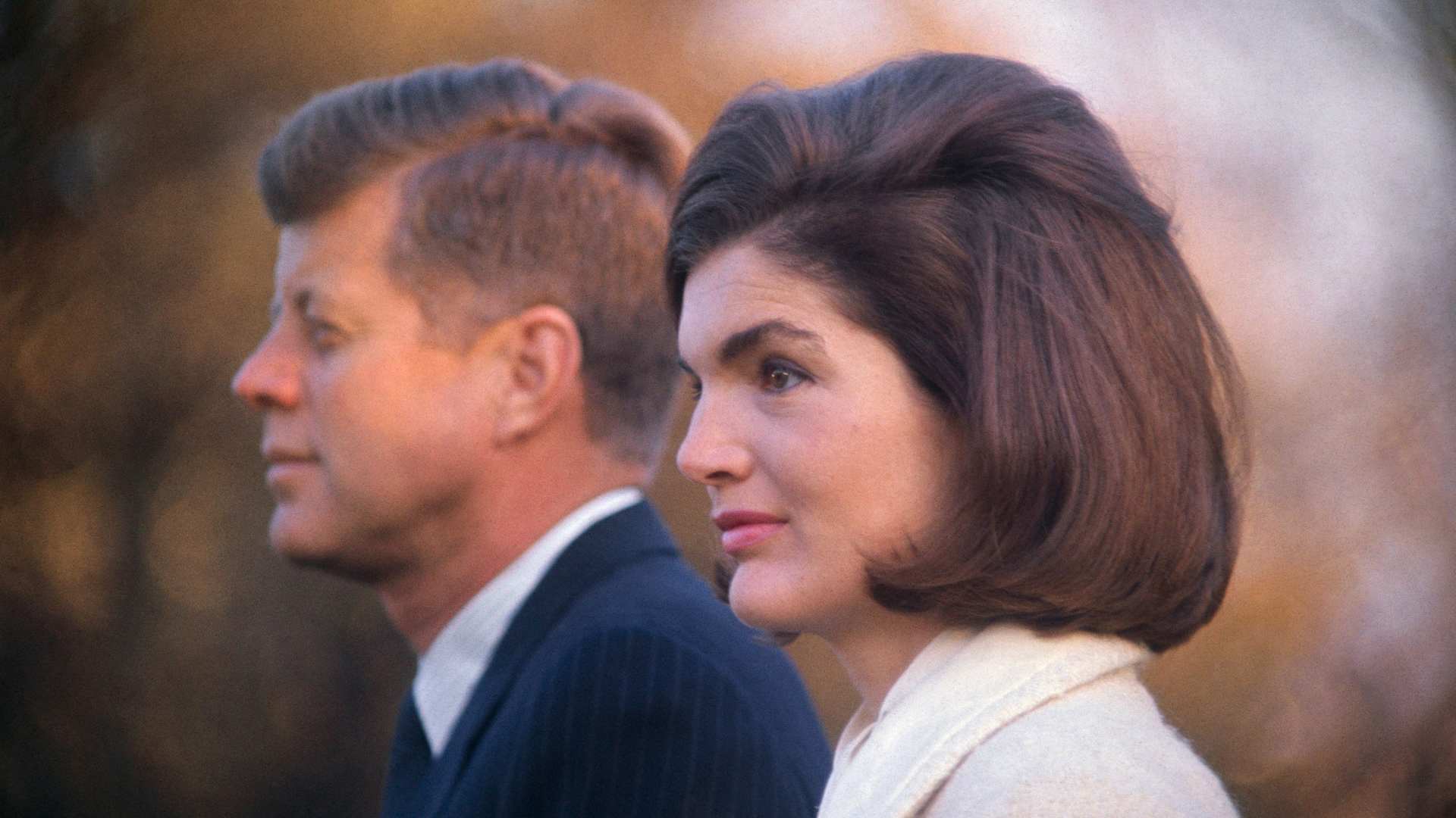 John F. Kennedy and Jackie Kennedy are shown on the White House lawn.
