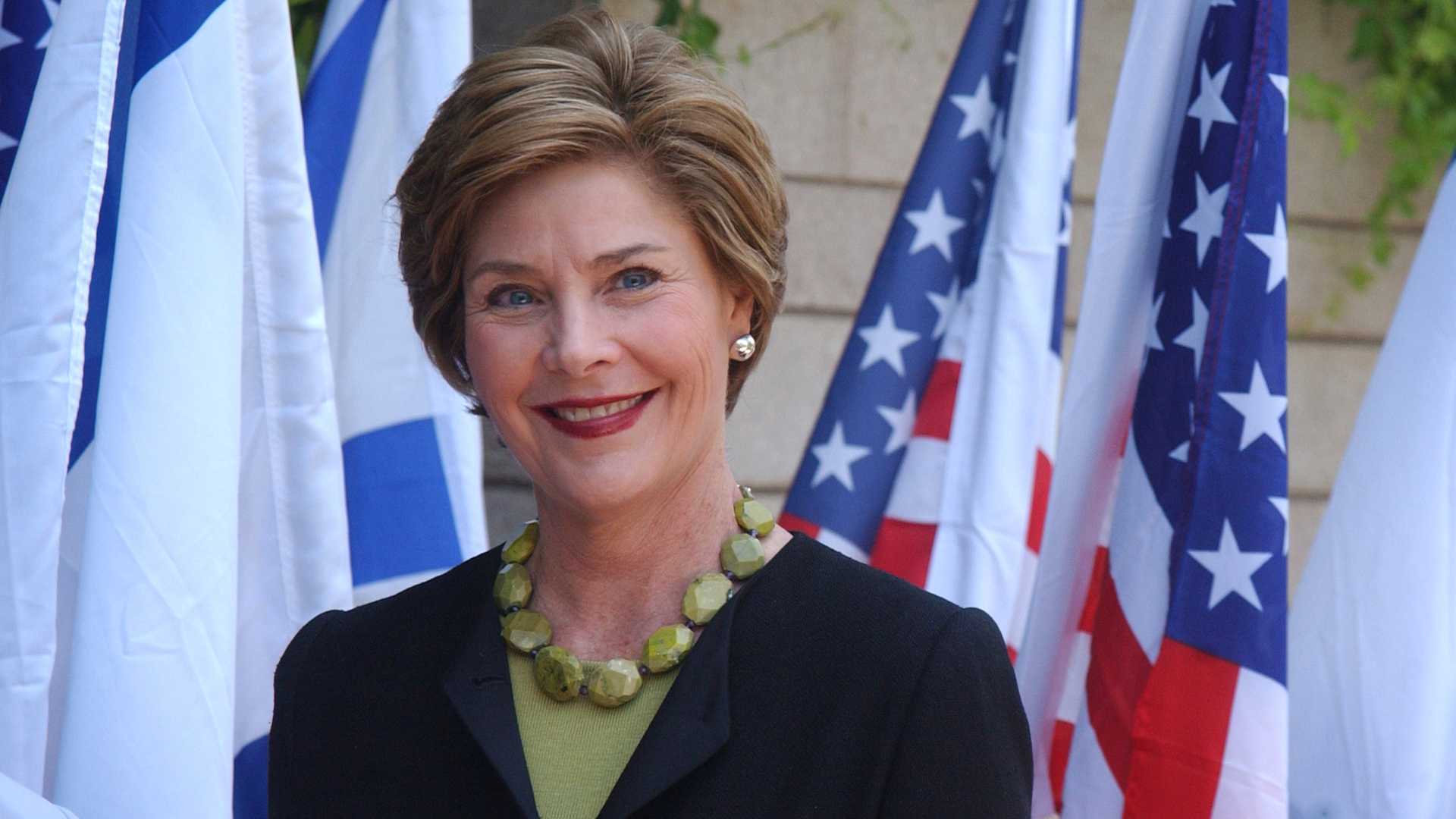 US first lady Laura Bush smiles after being greeted by Gila Katzav, the wife of Israeli President Moshe Katzav, at the president house in Jerusalem Sunday, May 22, 2005. Mrs. Bush arrived in Israel for a one-day visit, that will include the Palestinian town of Jericho, from Jordan where she attended the World Economic Forum conference on the Middle East on Saturday. (Photo by Lior Mizrahi/Getty Images)