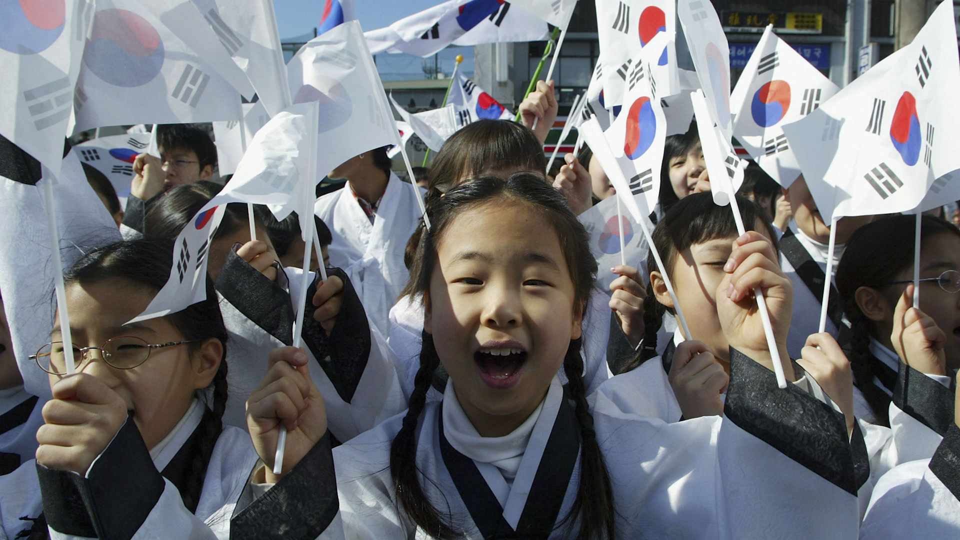 SEOUL, SOUTH KOREA - MARCH 1: South Korean children wearing traditional costume wave national flags during the celebration of The March First Independence Movement Anniversary on March 1, 2005 in Seoul, South Korea. South Koreans celebrate the public holiday a day of remembrance to mark the 1919 civilian uprising against Japanese colonial rule from 1910-1945. A legacy of resentment and territorial disputes between the nations were renewed when the Japanese ambassador claimed last week, that Japan was the rightful owner of several largely uninhabited islands claimed by both Tokyo and Seoul. (Photo by Chung Sung-Jun/Getty Images)