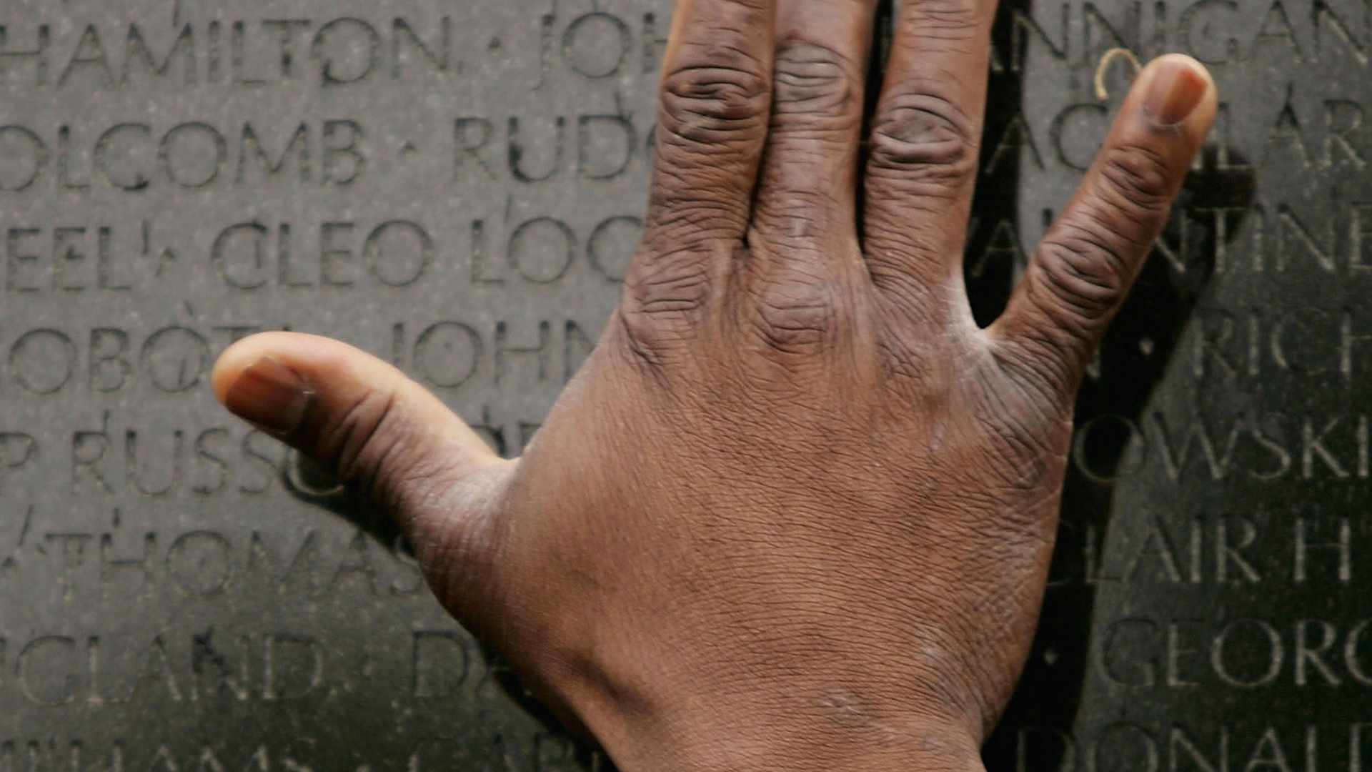 NEW YORK - APRIL 29: A man places his hand on the Vietnam Veterans Memorial where the names of 58 thousand Americans killed in the Vietnam War are listed April 29, 2005 in Washington, DC. Thirty years have passed since the end of the Vietnam War on April 30, 1975. On April 29, the North Vietnamese army took over Saigon, the capital of South Vietnam, and the last U.S. troops left Vietnam. (Photo by Spencer Platt/Getty Images)