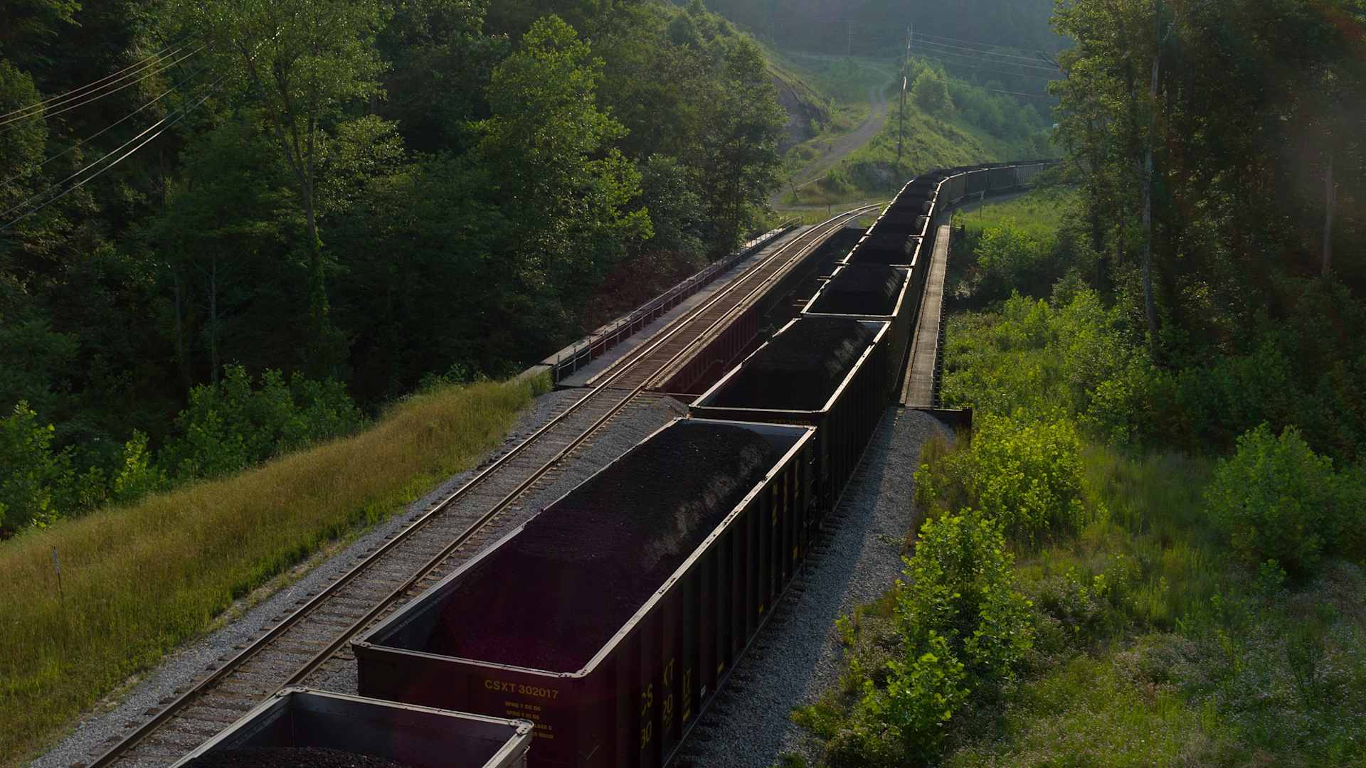 A train carrying several million dollars of high quality coal for export to China waits on the tracks outside of a coal processing plant near Blair, West Virginia. | Location: Logan County, WVA, USA. (Photo by Andrew Lichtenstein/Corbis via Getty Images)