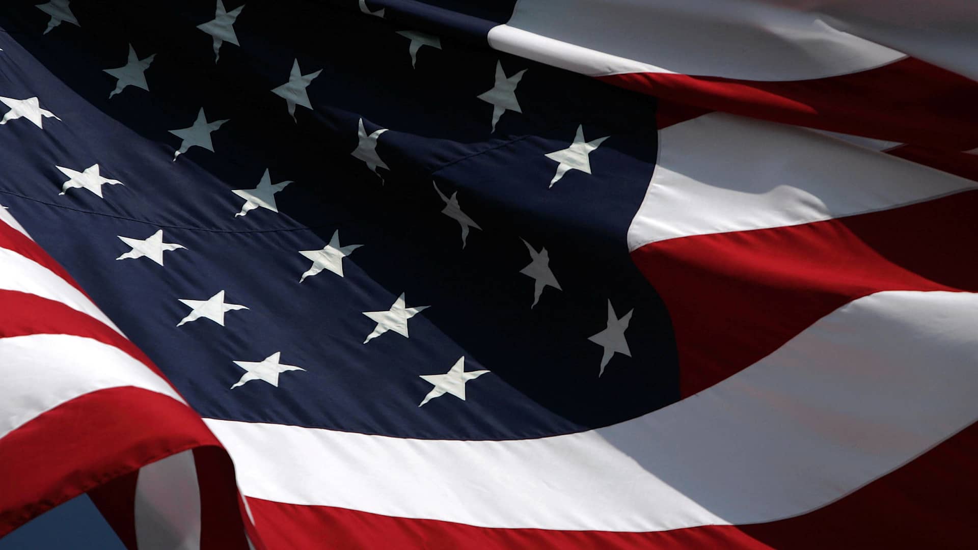 A large American flag rippling in the wind.