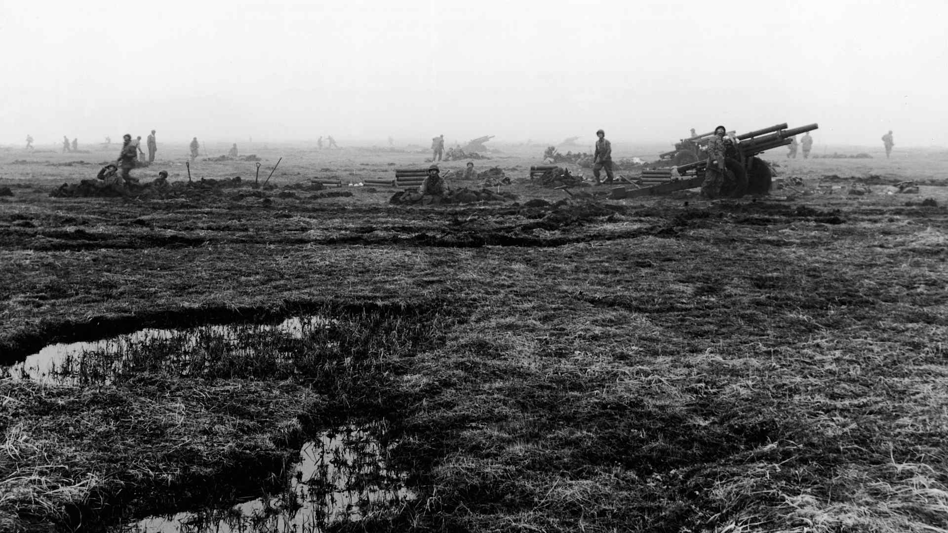 American soldiers on guard in a muddy field look towards the hills for hiding Japanese troops at Attu in the Aleutian Islands, Alaska, May 11, 1943. The troops landed that day on the Japanese occupied island, which would ultimately become a battleground for both American and Japanese casualites. (Photo by Frederic Lewis/Getty Images)
