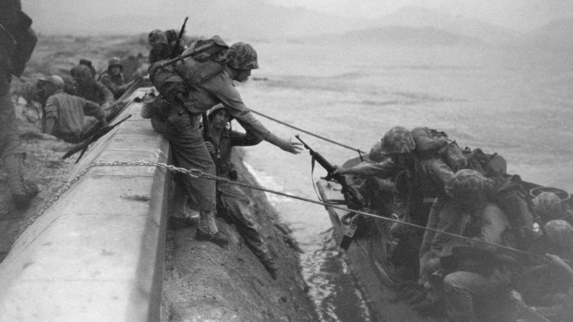 US Marines climb from their landing craft at the seawall in Inchon, Korea. (Photo by © Hulton-Deutsch Collection/CORBIS/Corbis via Getty Images)