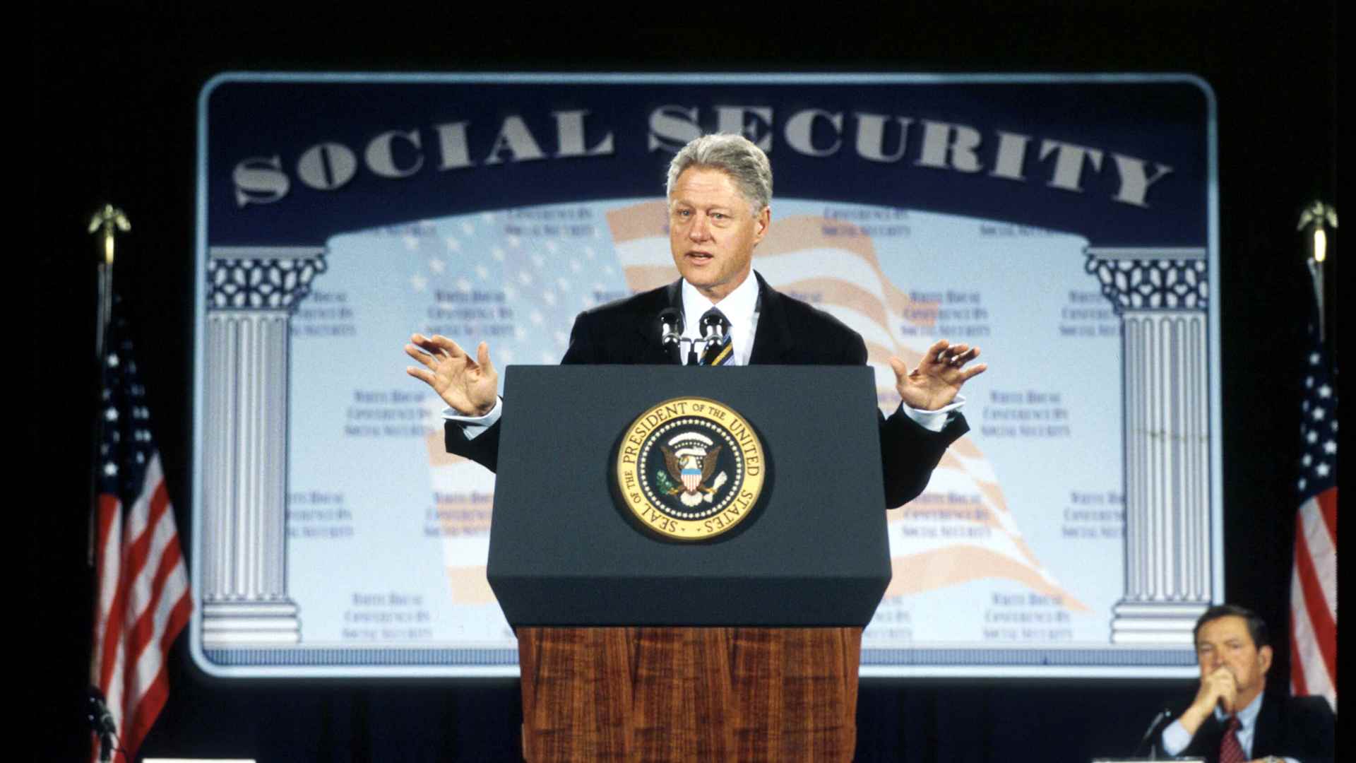 President Bill Clinton addressing a White House conference to discuss ideas about how best to reform Social Security to ensure its solvency well into the 21st century, 1998.
