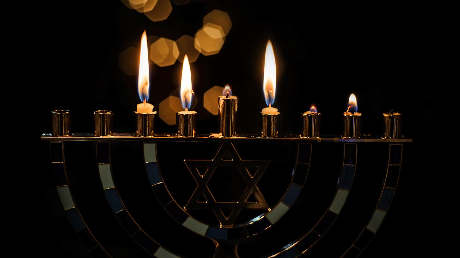 A partially lit Hanukkah menorah.