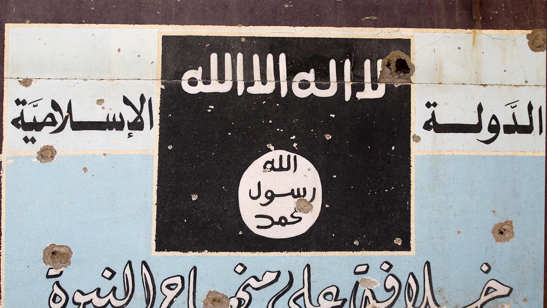 A picture shows a mural depicting the emblem of the Islamic State (IS) group