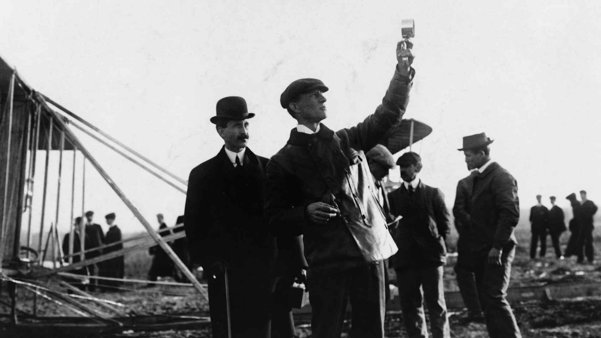Picture of the Wright Brothers with Orville watching Wilbur take readings outdoors, circa 1908. (Photo by Fotosearch/Getty Images).